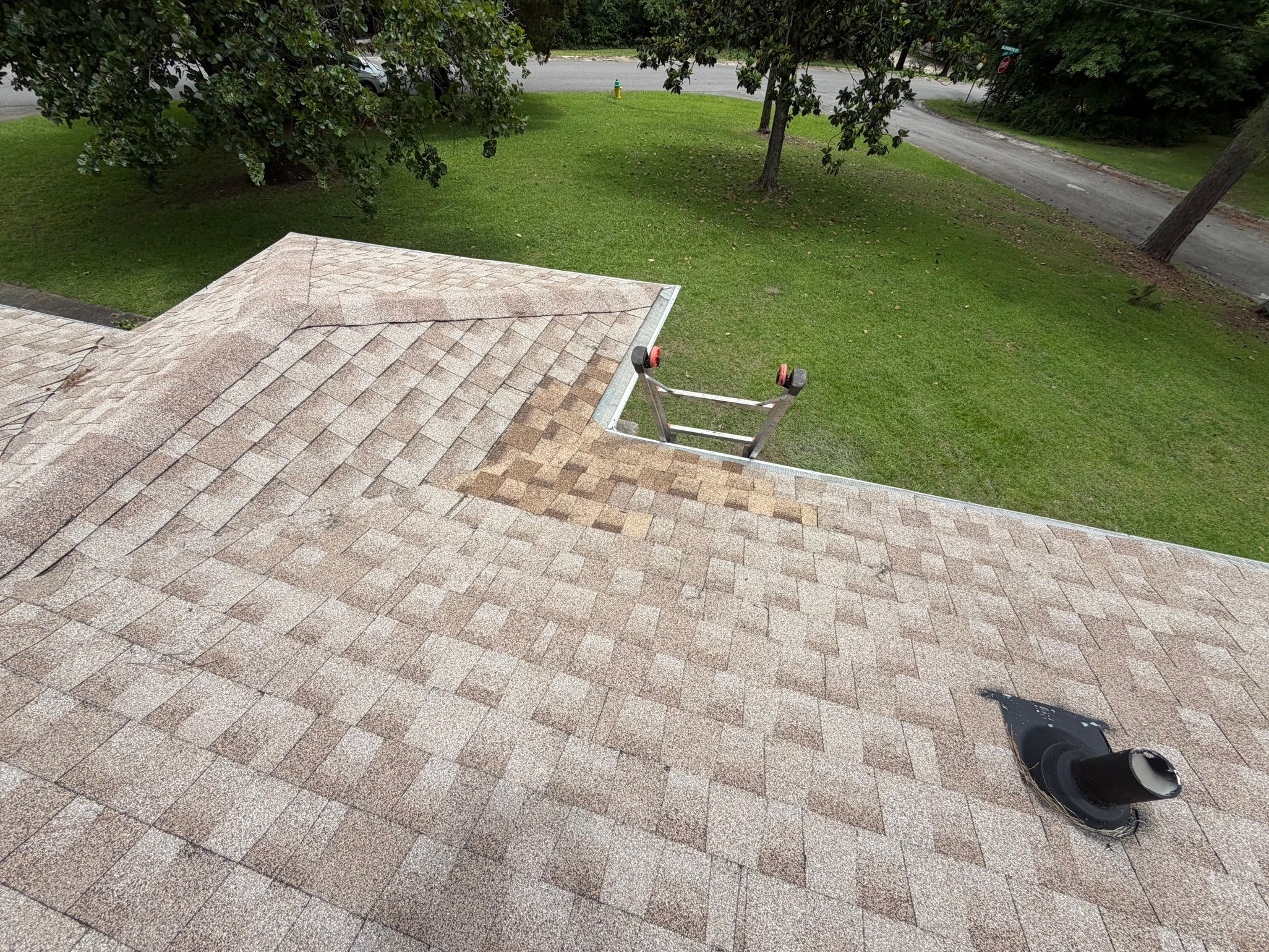 Newly patched brown architectural shingles blend into an existing roof plane in Cahaba Hills.
