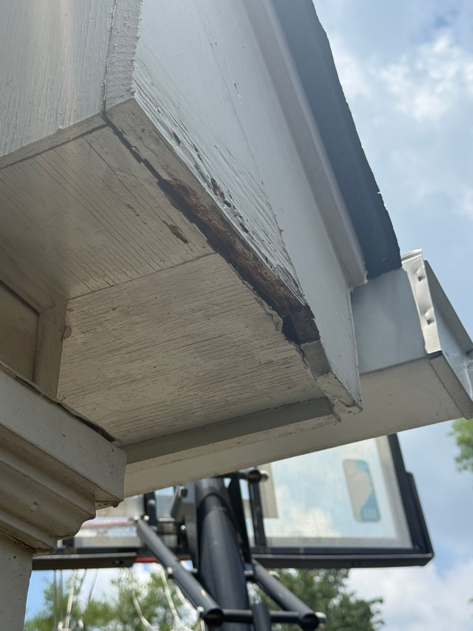 Severely decayed soffit wood under the roof overhang requires targeted repair in Mountain Brook.