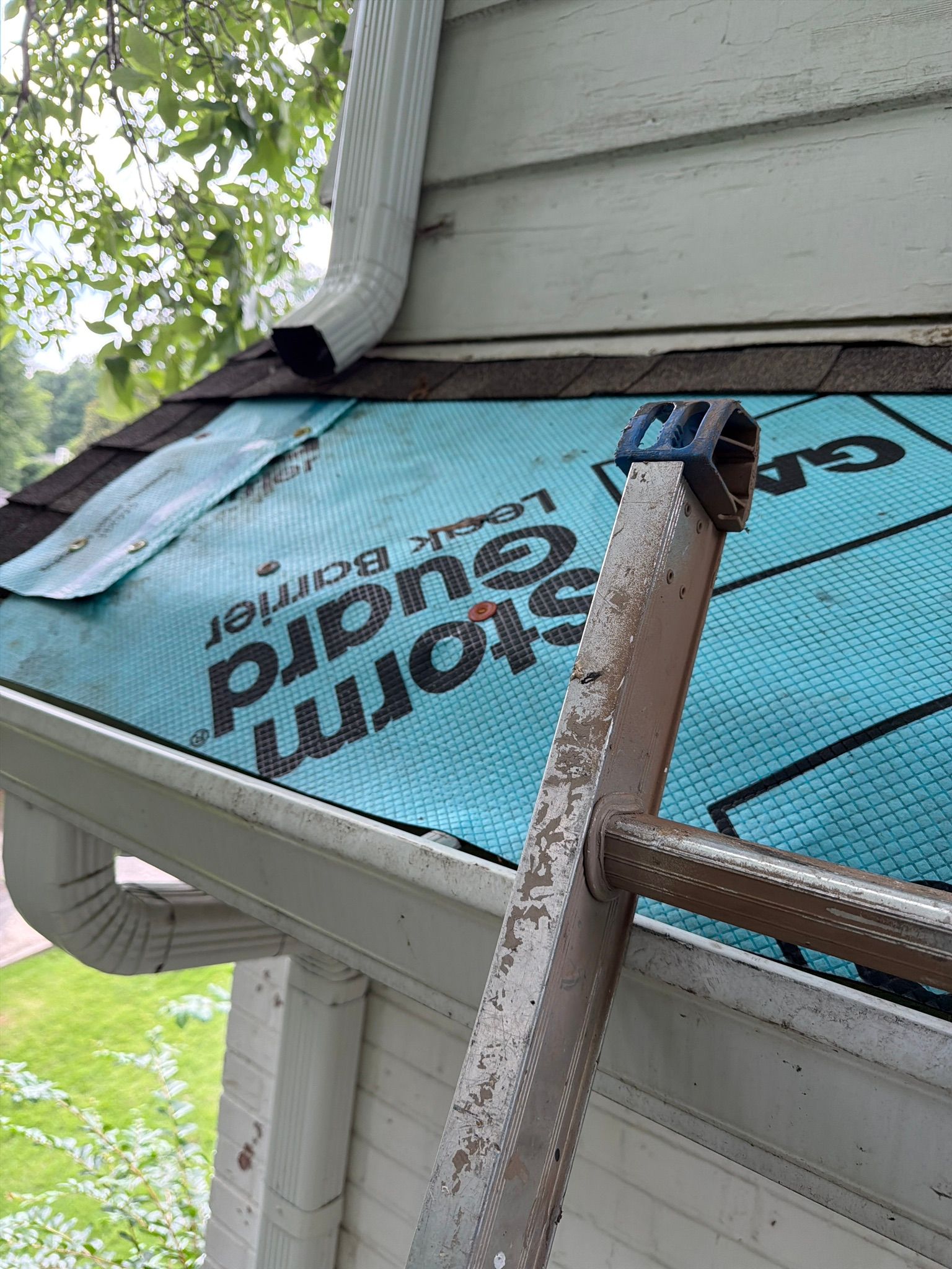 New blue leak barrier underlayment covers the prepped roof deck during a Mountain Brook roof repair.