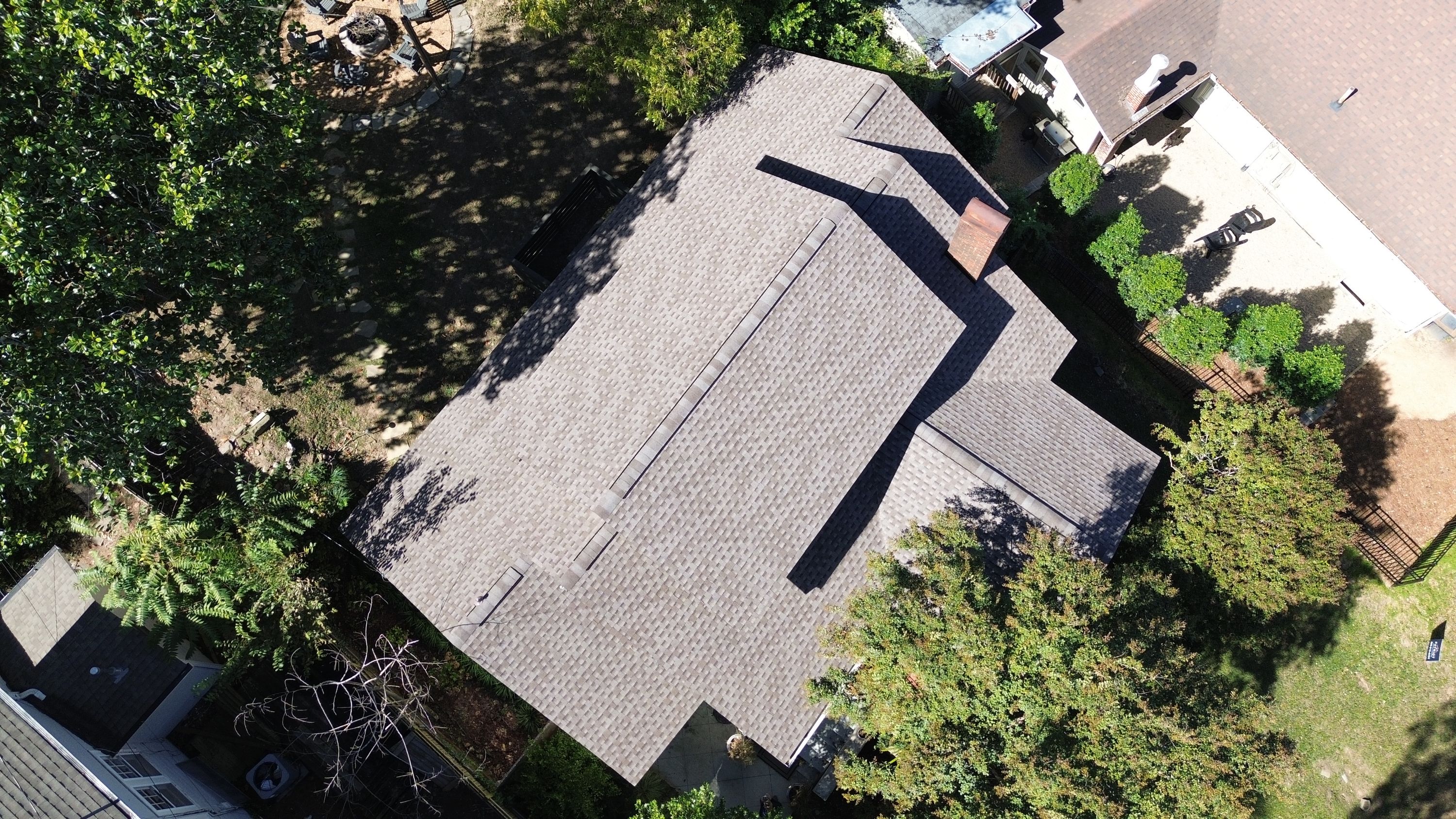 Overhead view of a completed roof replacement in Forest Park showing the main ridge vent and broad shingle slopes.
