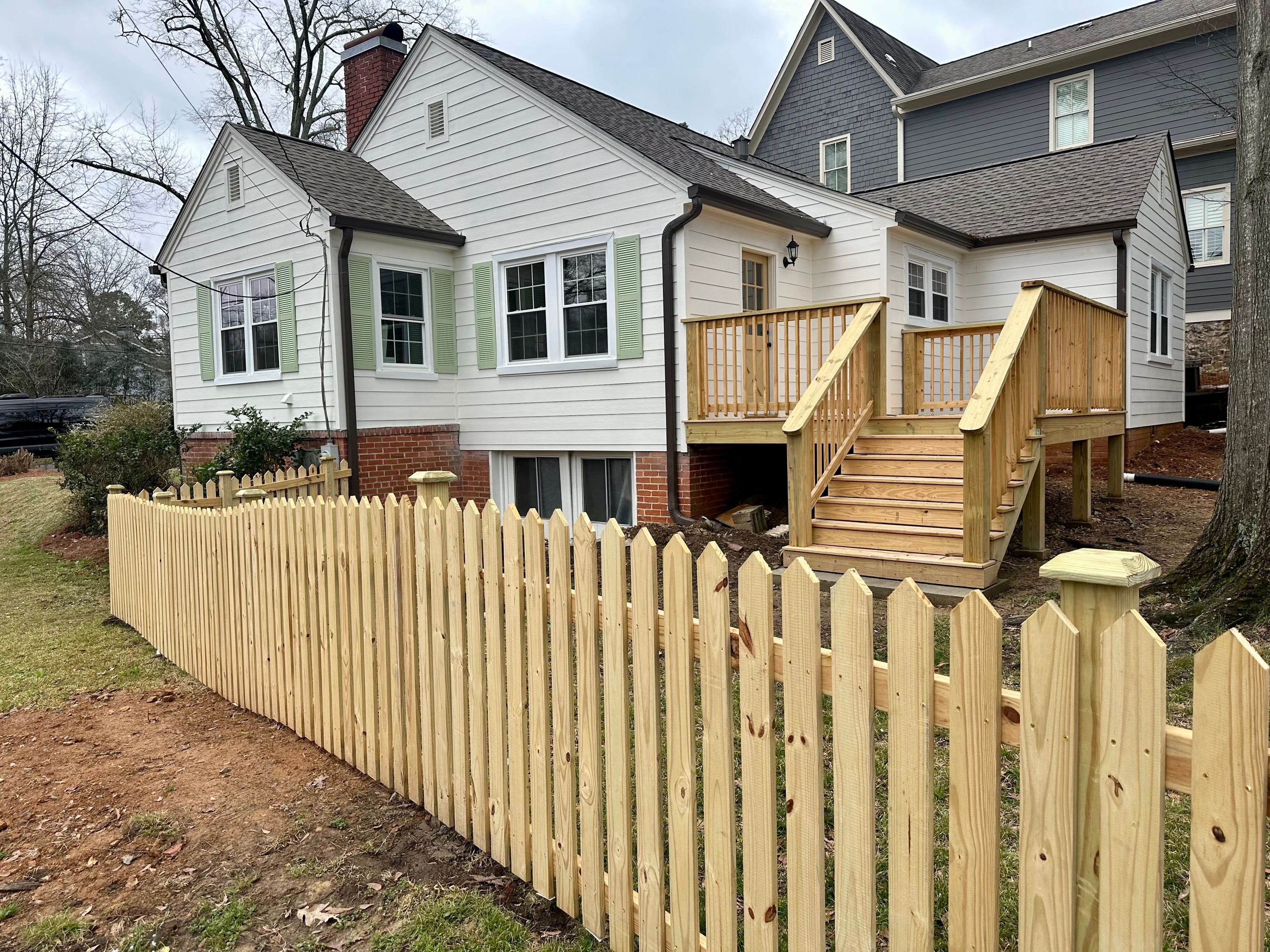 New custom wood deck and picket fence installation for a residential home in Homewood.