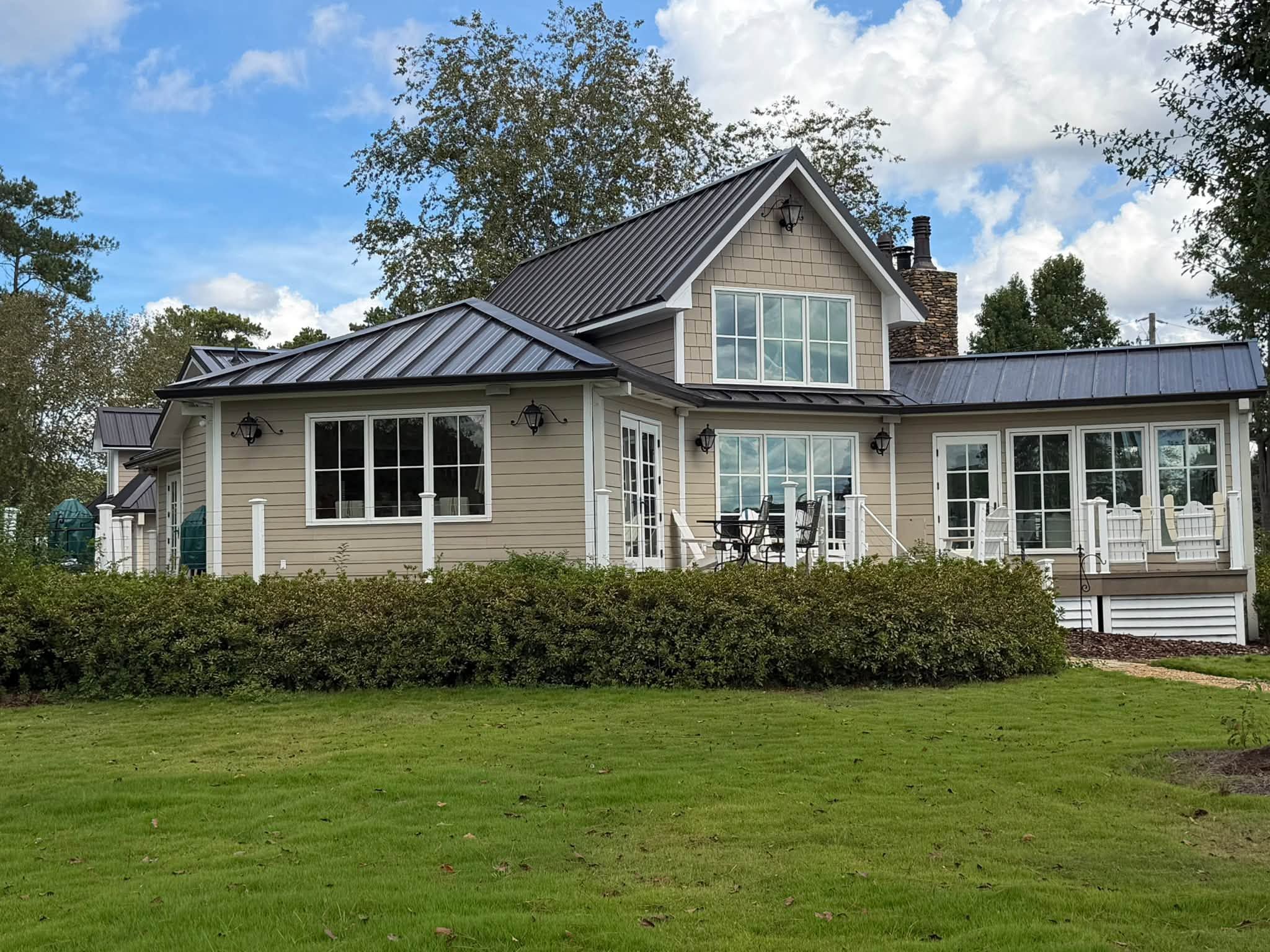 A newly replaced metal roof covers the upper gables and porch overhang of a Wilsonville residence.