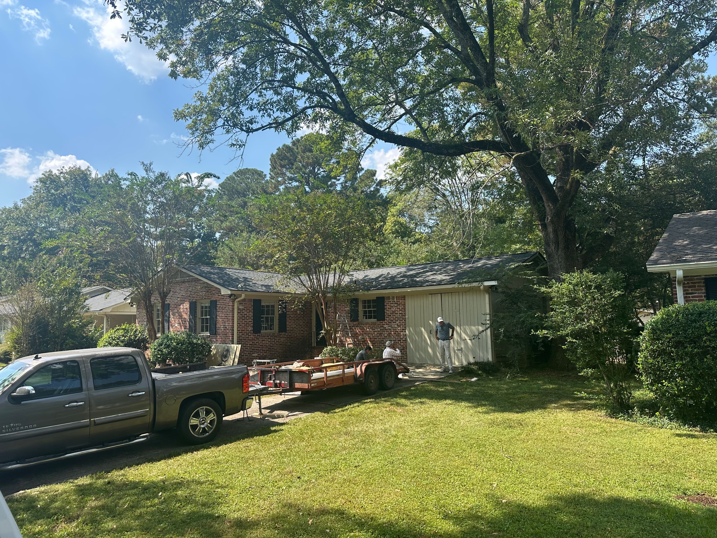 Newly installed dark asphalt shingle roof on a brick home in Crestline Gardens, Birmingham.