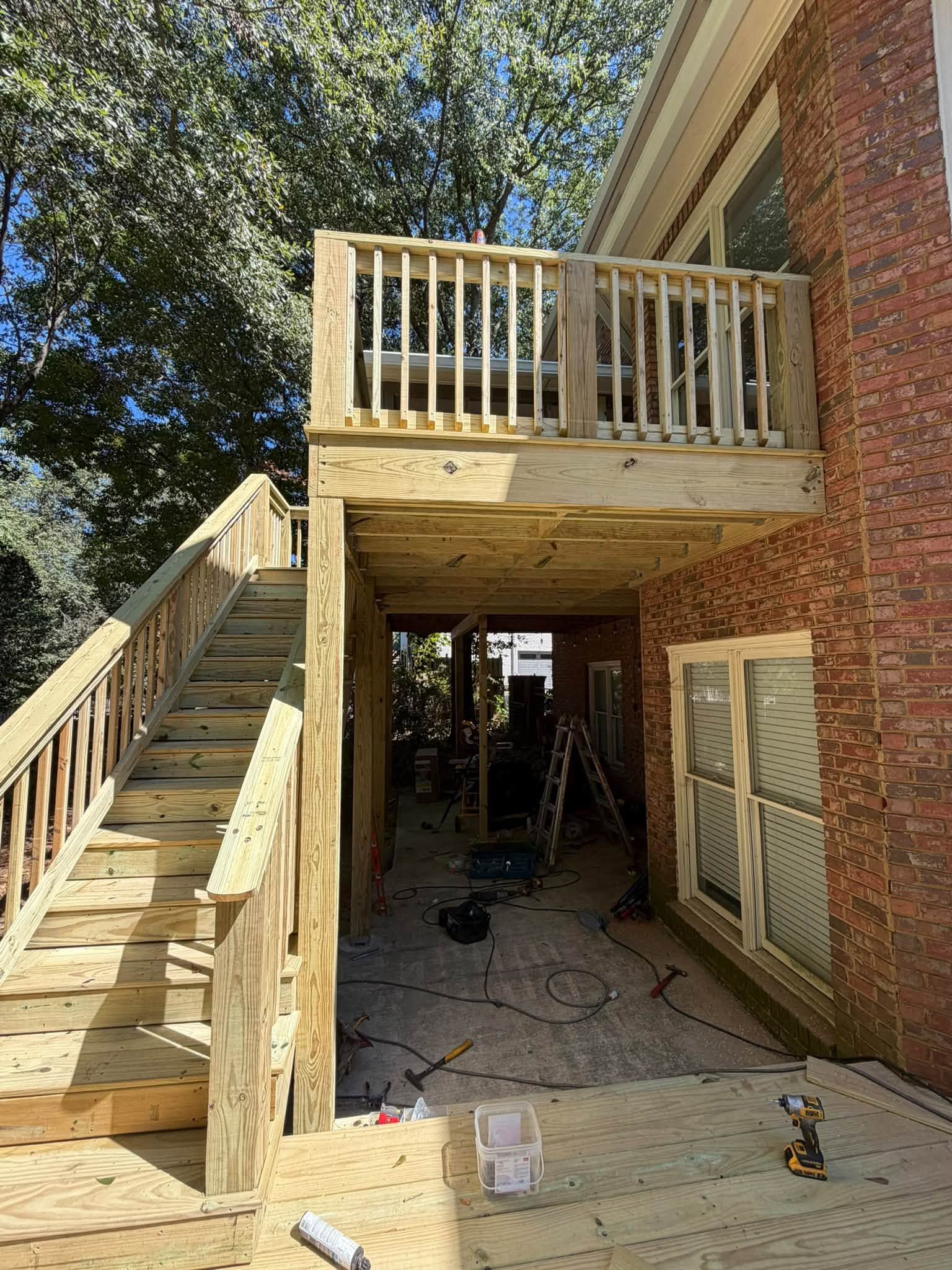 Finished guardrails enclose the upper deck section above the lower patio area in Hoover.