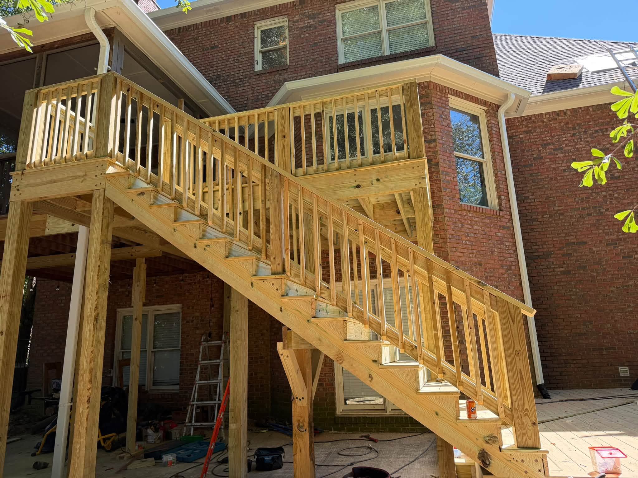 Side view of wooden staircase railings and support posts built for a multi-level deck in Windchase.