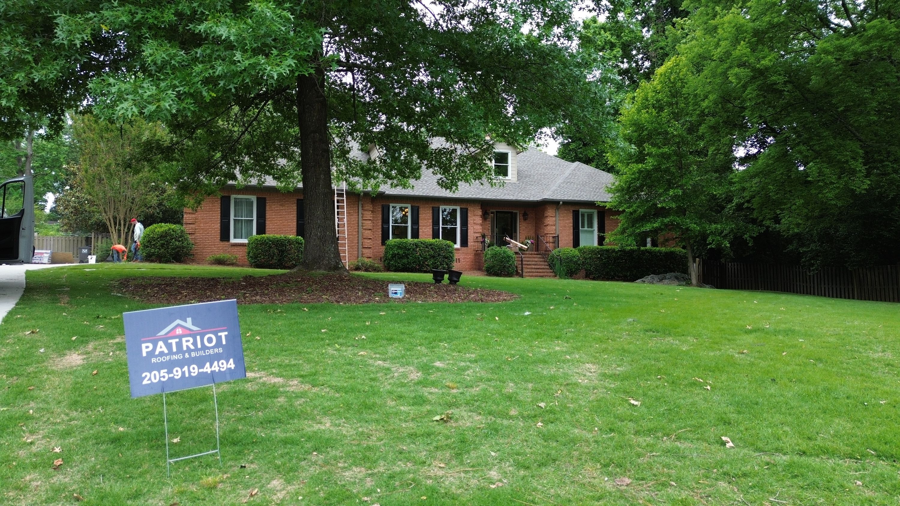Roof replacement with asphalt shingles underway on a brick home in the Carisbrooke neighborhood of Hoover.