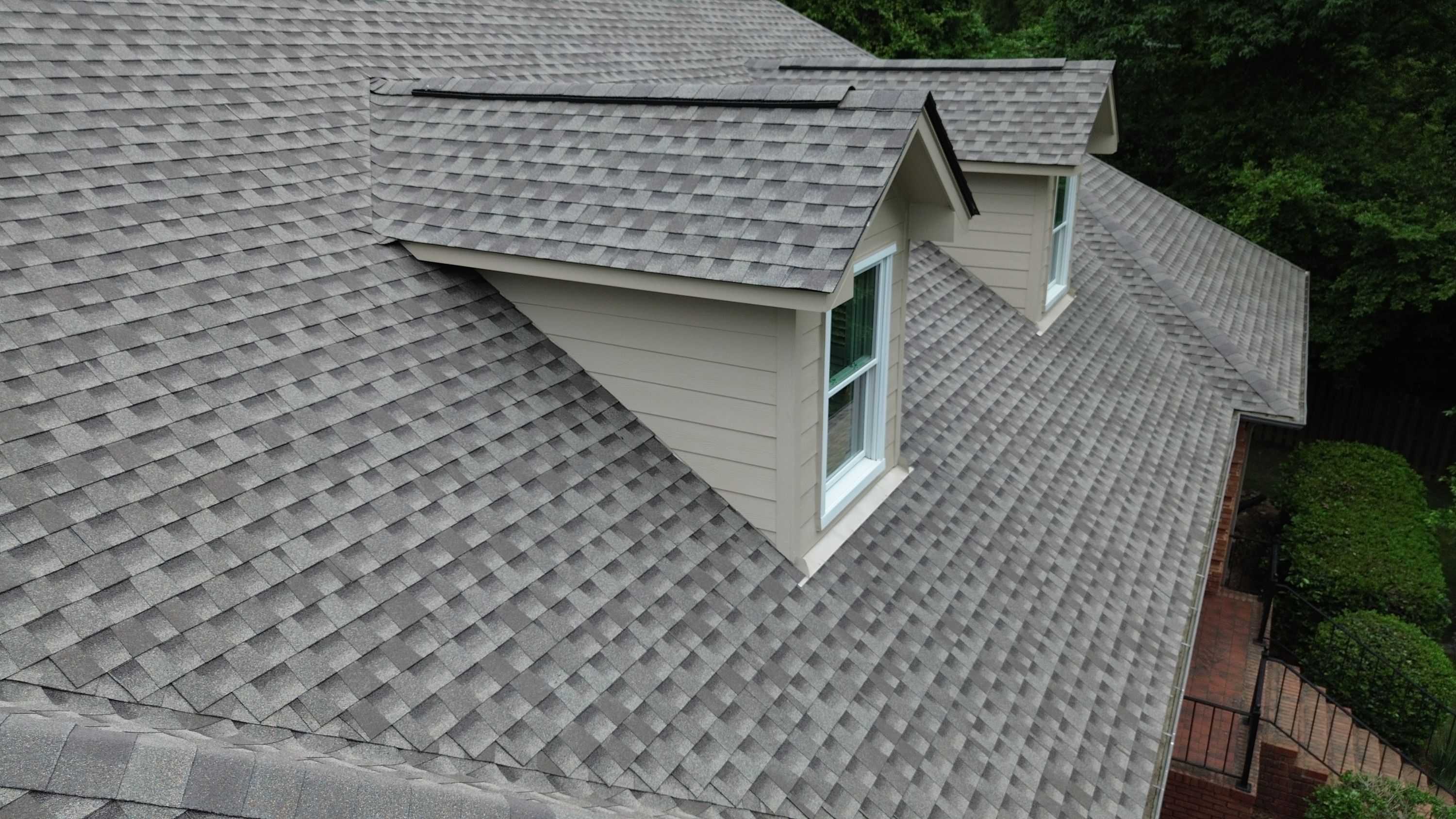 A completed shingle roof replacement and siding installation on a home in the Carisbrooke neighborhood of Hoover.