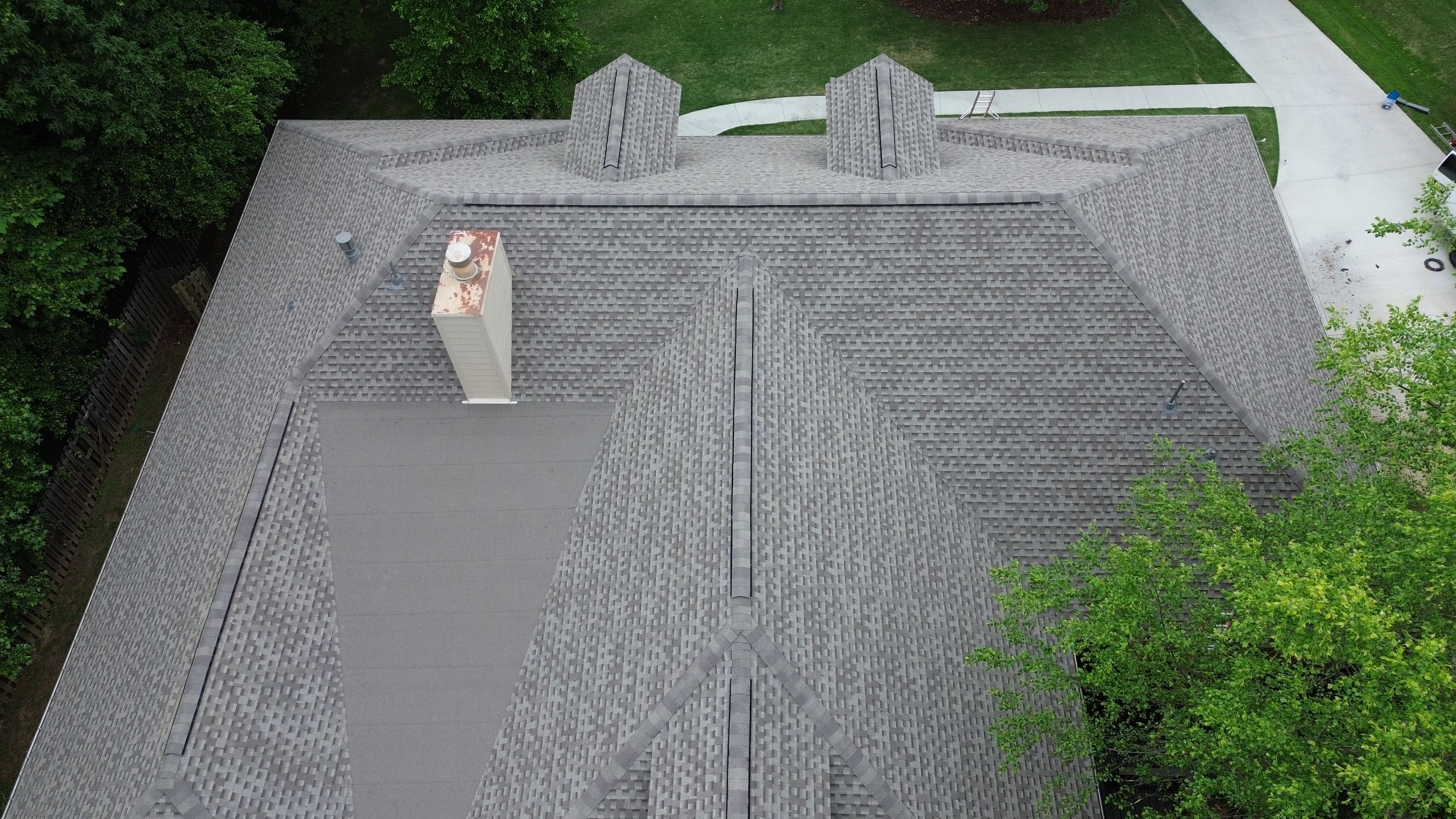 Aerial view of a completed shingle roof replacement on a home in the Carisbrooke neighborhood of Hoover.