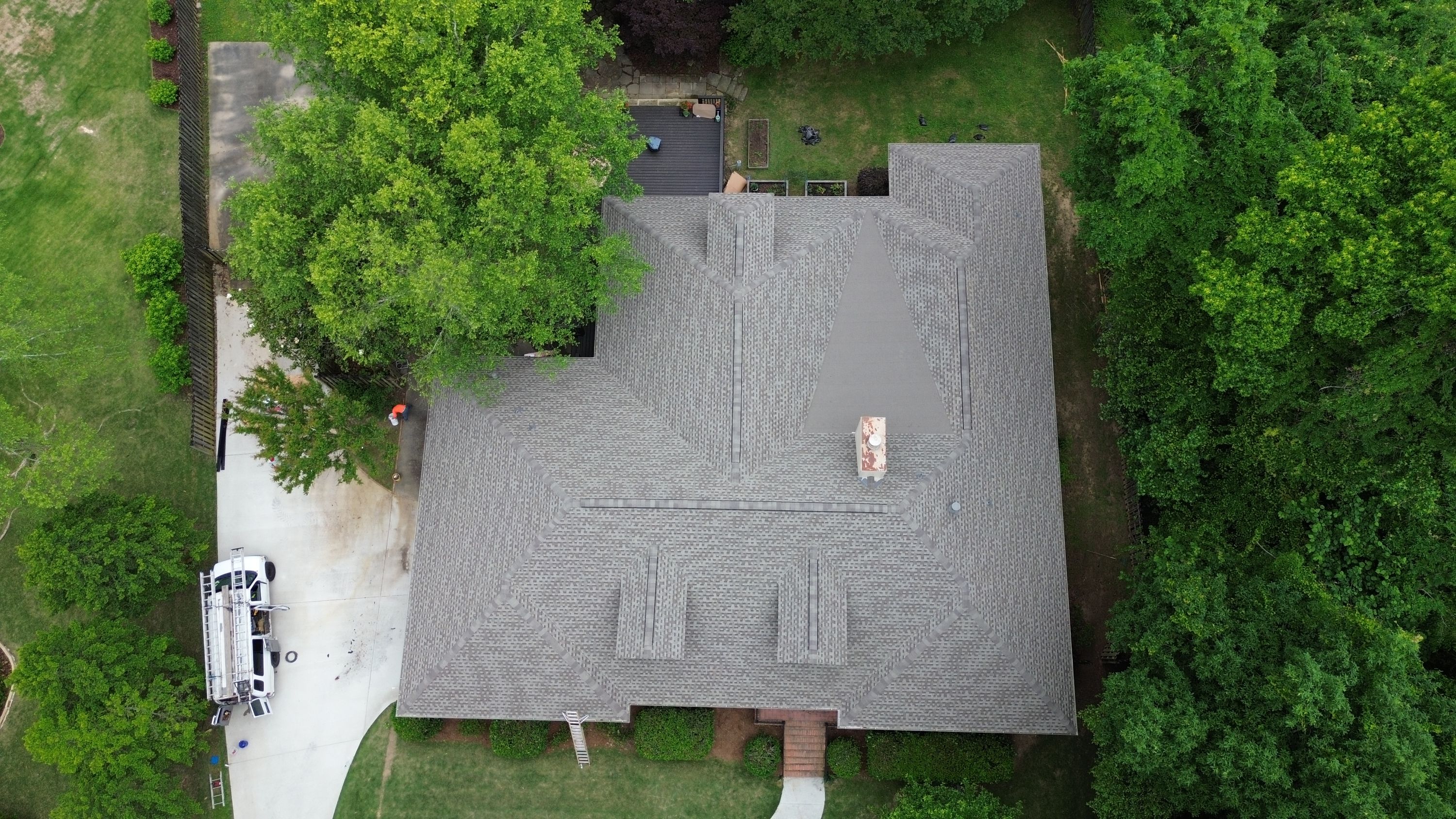 Aerial view of a completed shingle roof replacement on a home in the Carisbrooke neighborhood of Hoover.