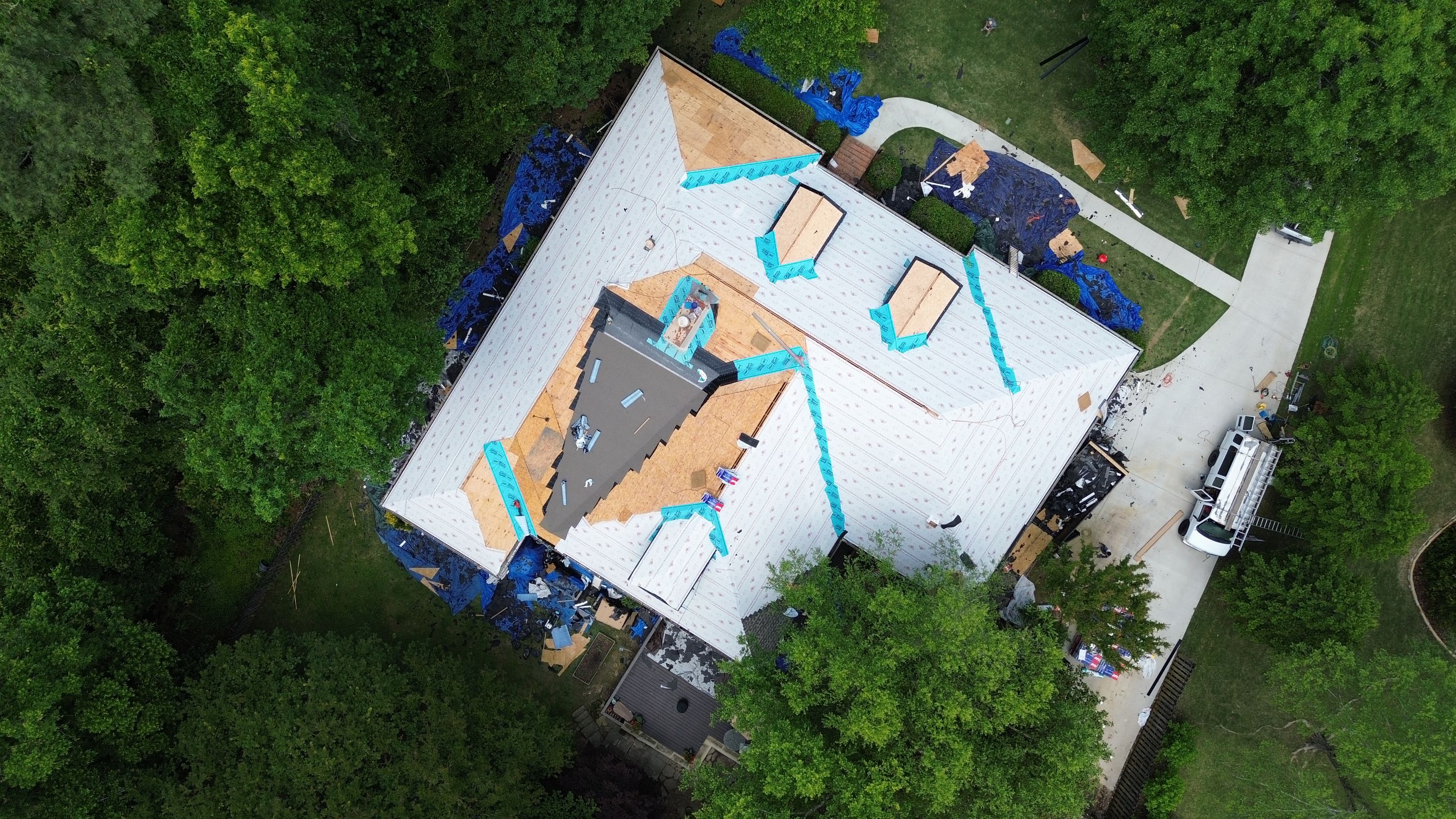 Aerial view of a roof replacement in progress with new plywood decking and underlayment in Carisbrooke, Hoover.