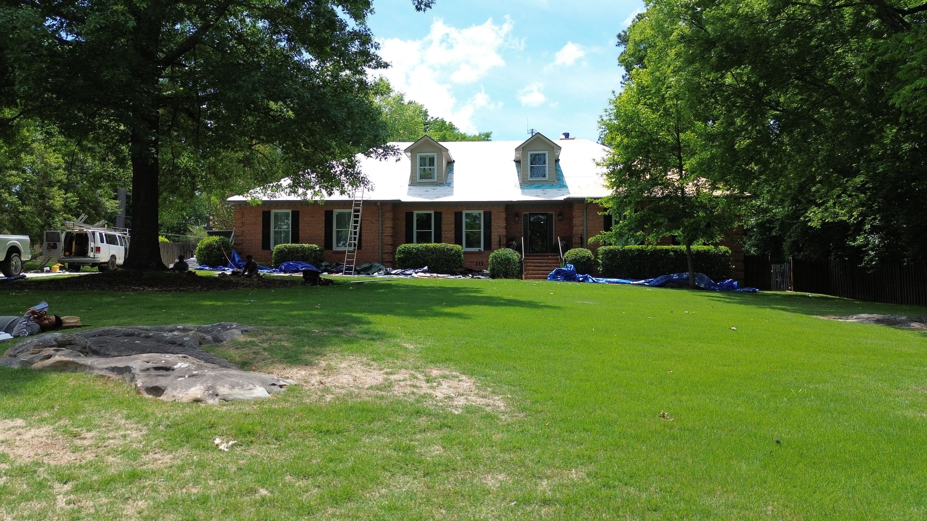 Roof replacement in progress on a brick home in the Carisbrooke neighborhood of Hoover.
