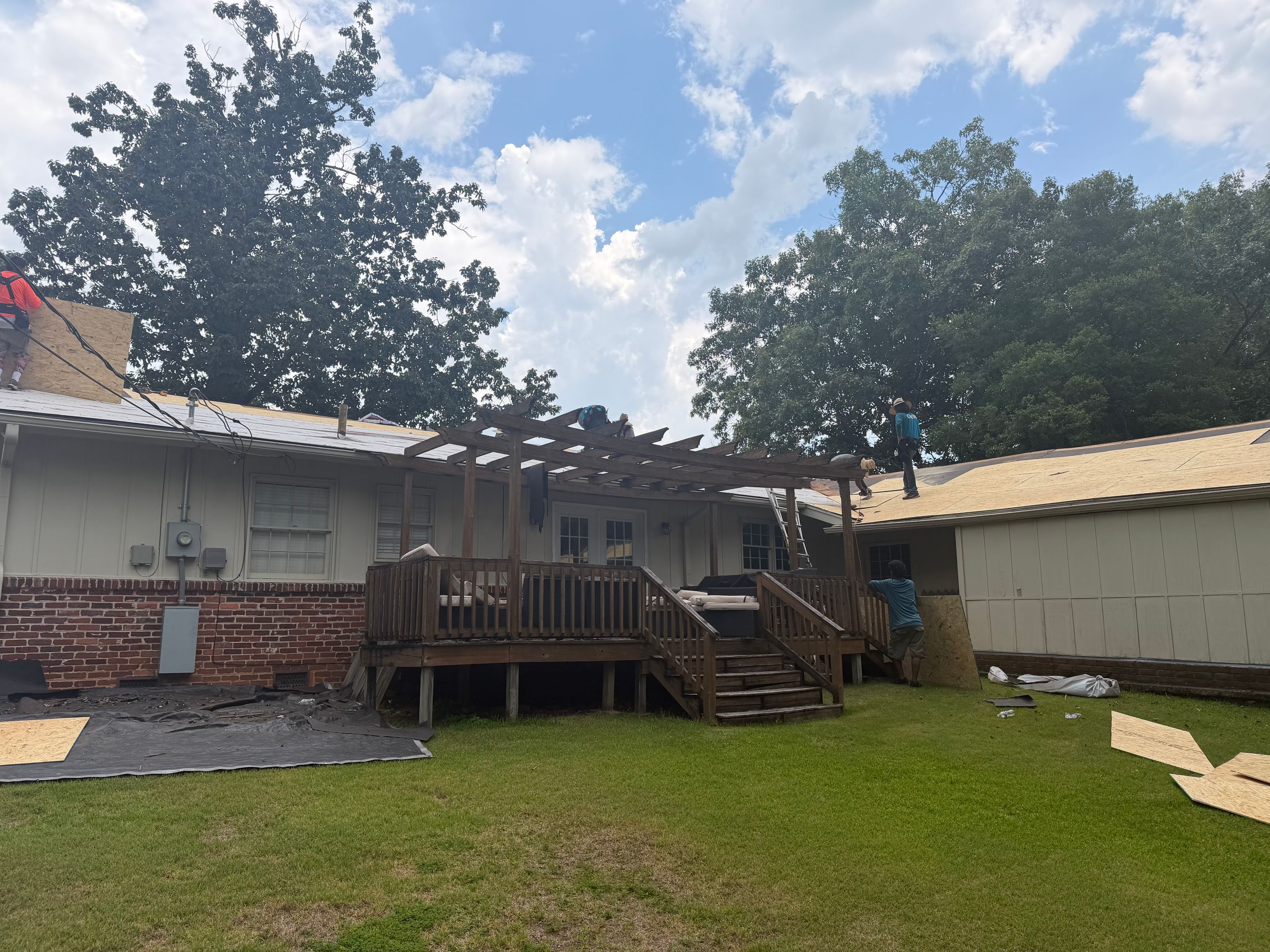 An upward angle captures the wooden pergola beams mounted above the back deck of this Gentilly Forest home.