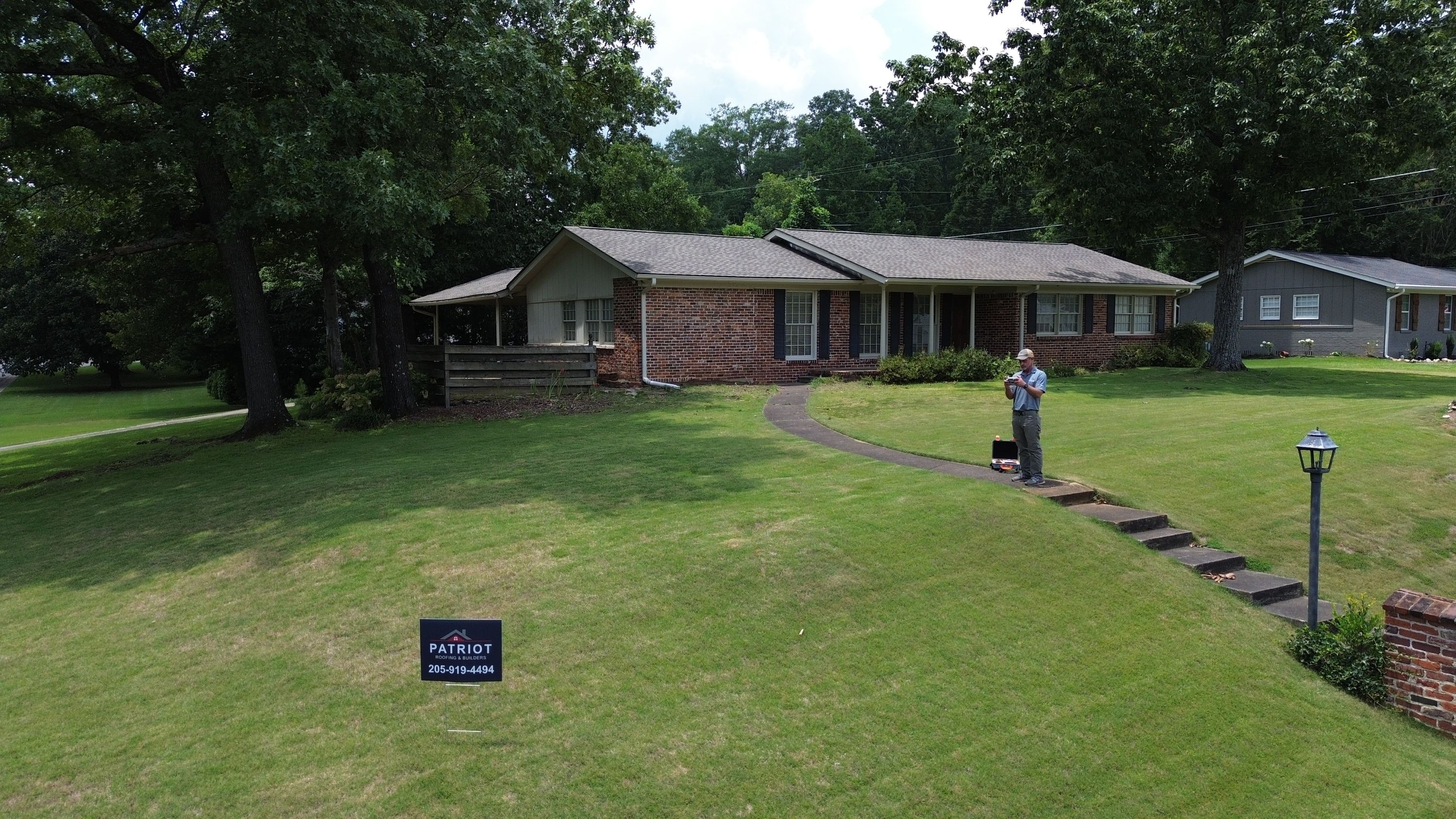 New grey shingles cover the roof of this brick ranch home, seen from the front lawn on Columbiana Road.
