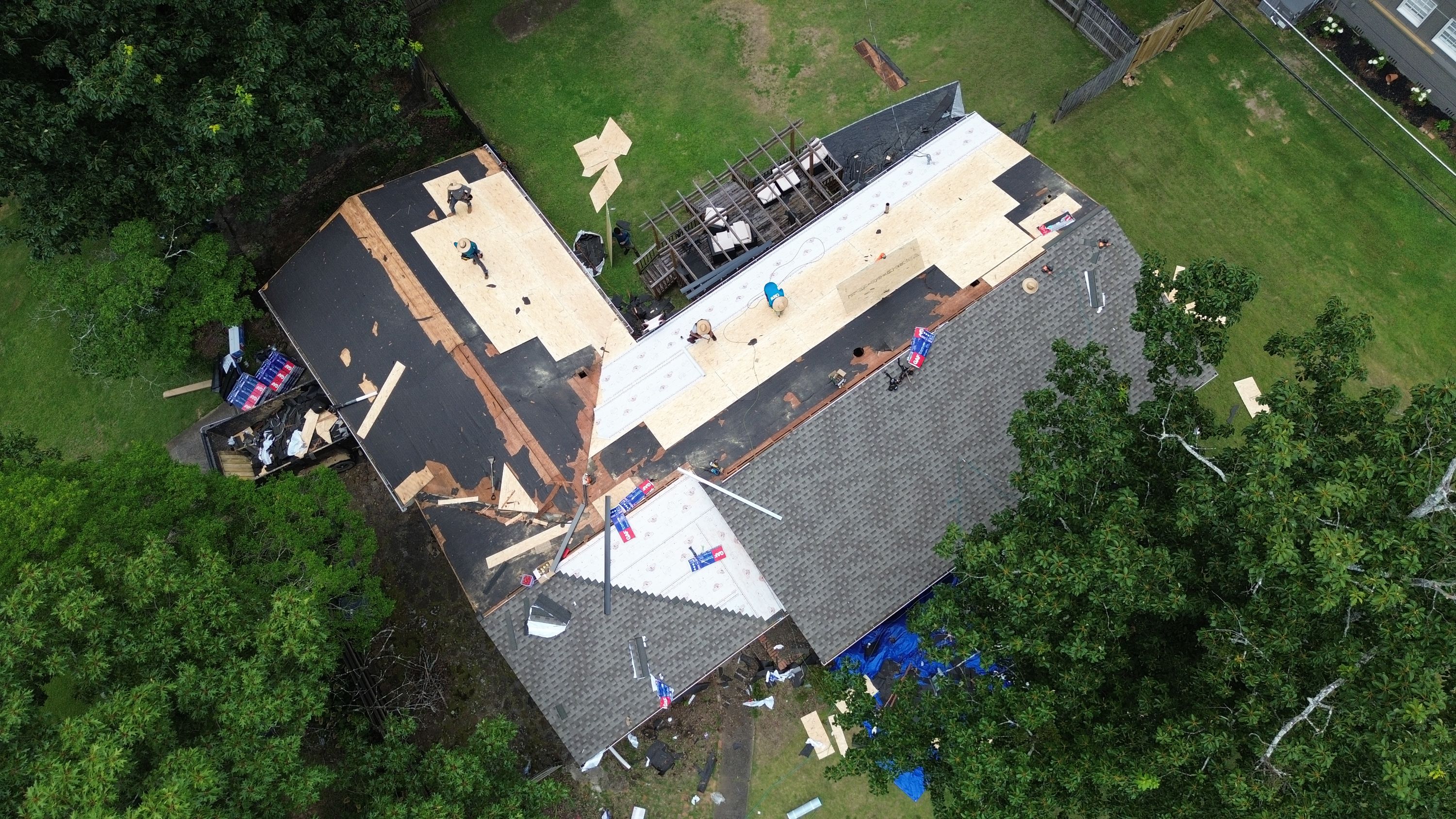 New grey architectural shingles are installed on a multi-plane roof replacement project in Gentilly Forest.