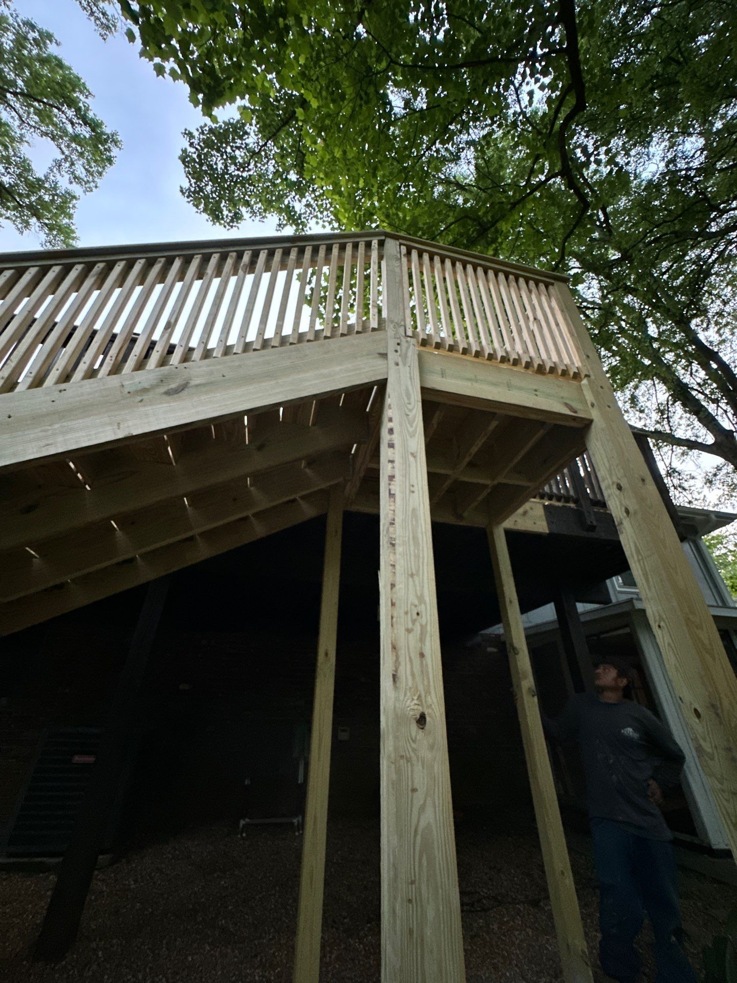 A newly constructed wooden deck with railings installed on a home in Vestavia Hills.