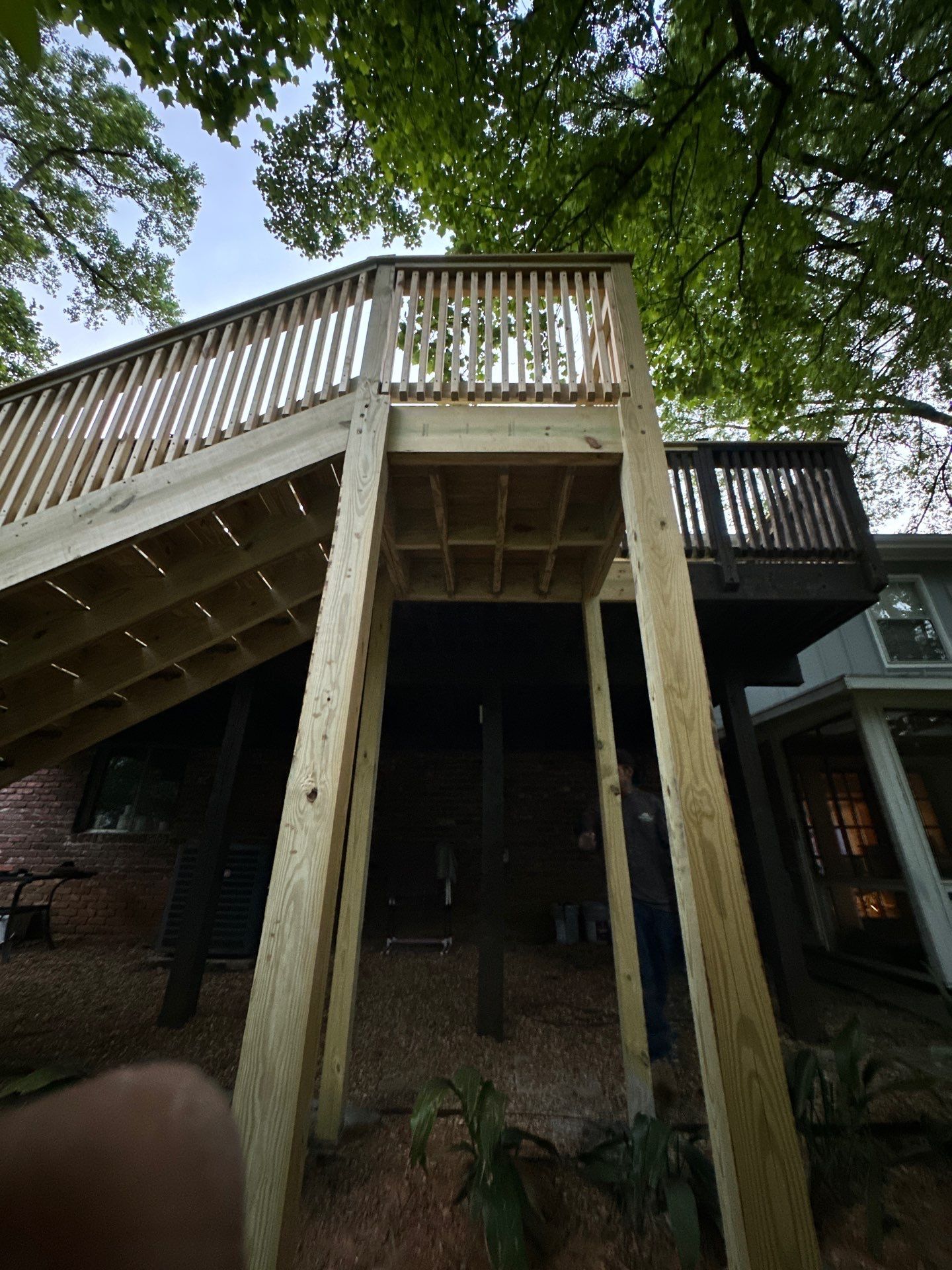 A newly constructed wooden deck with stairs and railings installed at a home in Vestavia Hills.