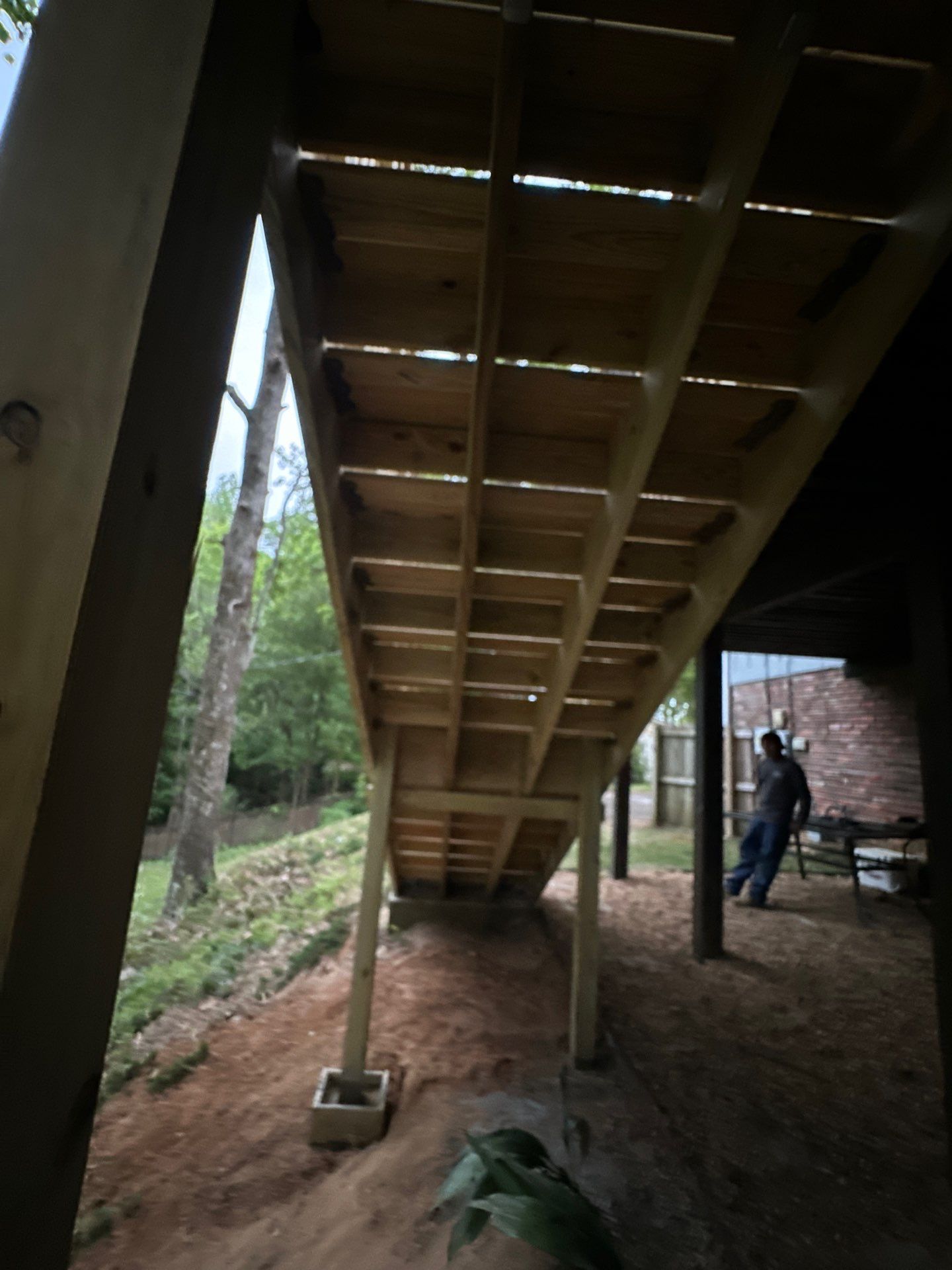 Underside view of a new wooden deck staircase under construction in Vestavia Hills.