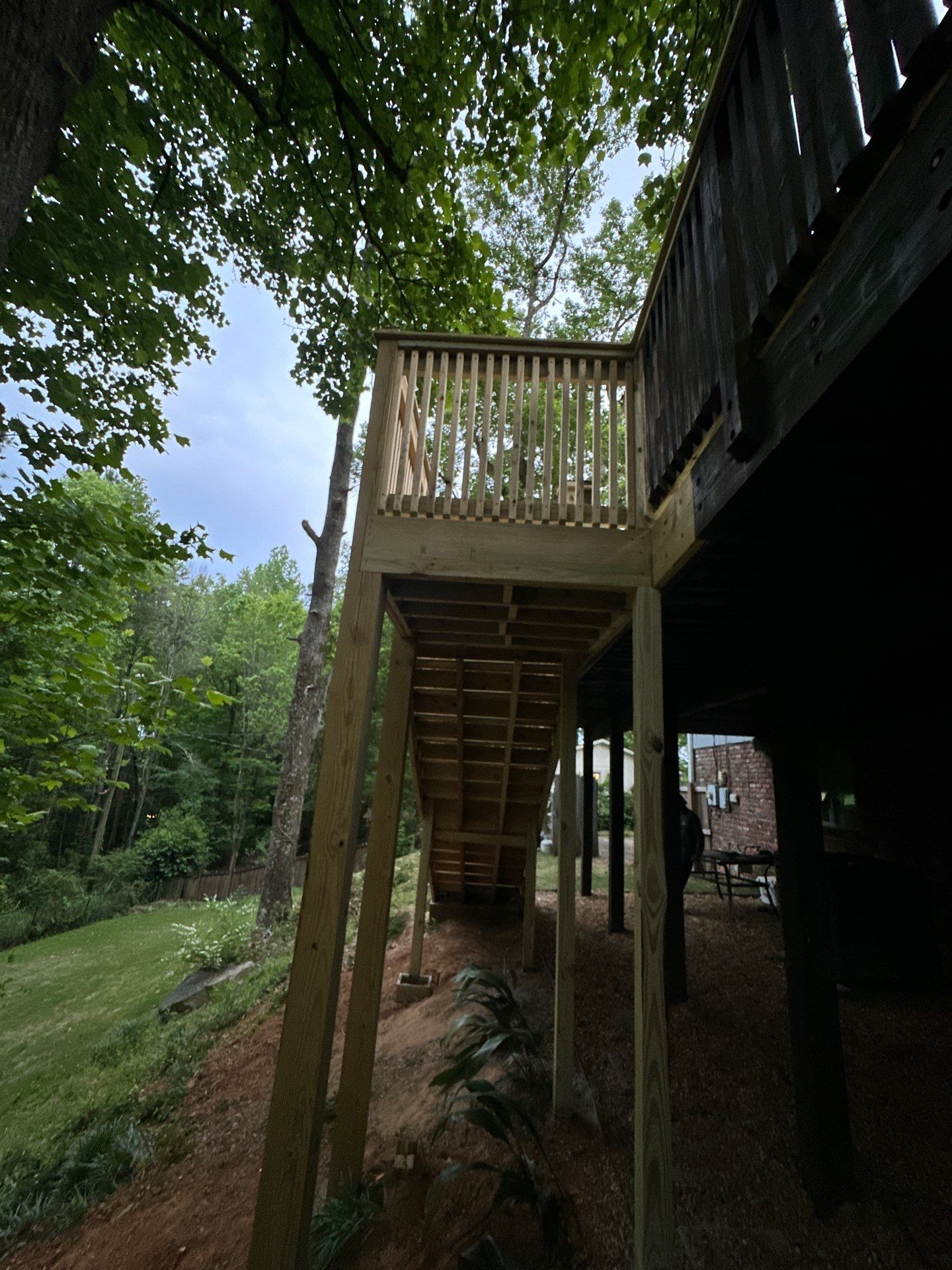 A newly constructed wooden deck staircase built on a residential property in Vestavia Hills.