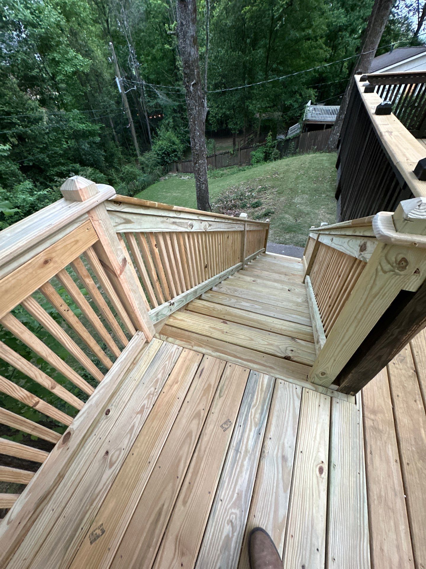 Newly installed wooden deck stairs with railings at a home on Woodmere Dr in Vestavia Hills.