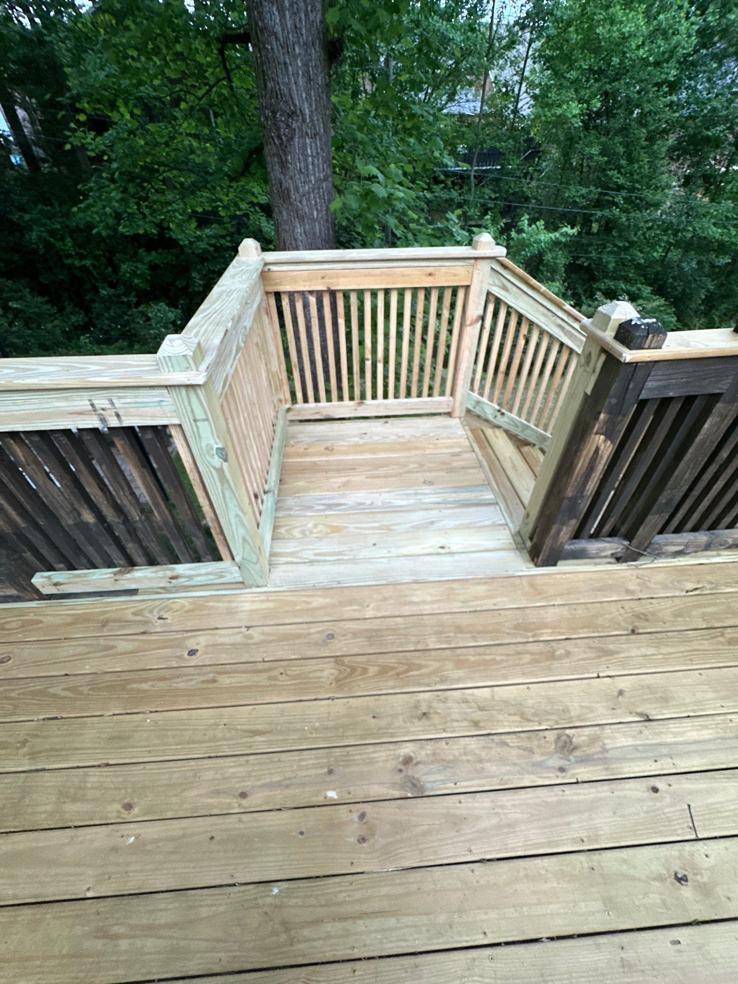 A newly constructed wooden deck with railings on Woodmere Dr in Vestavia Hills.