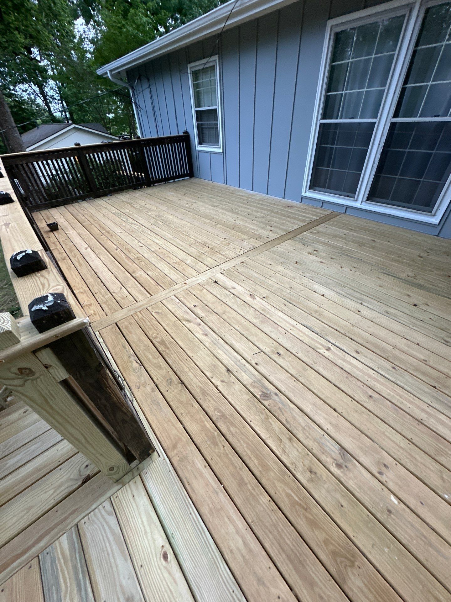 A newly installed wood deck with railings at a home on Woodmere Dr in Vestavia Hills.