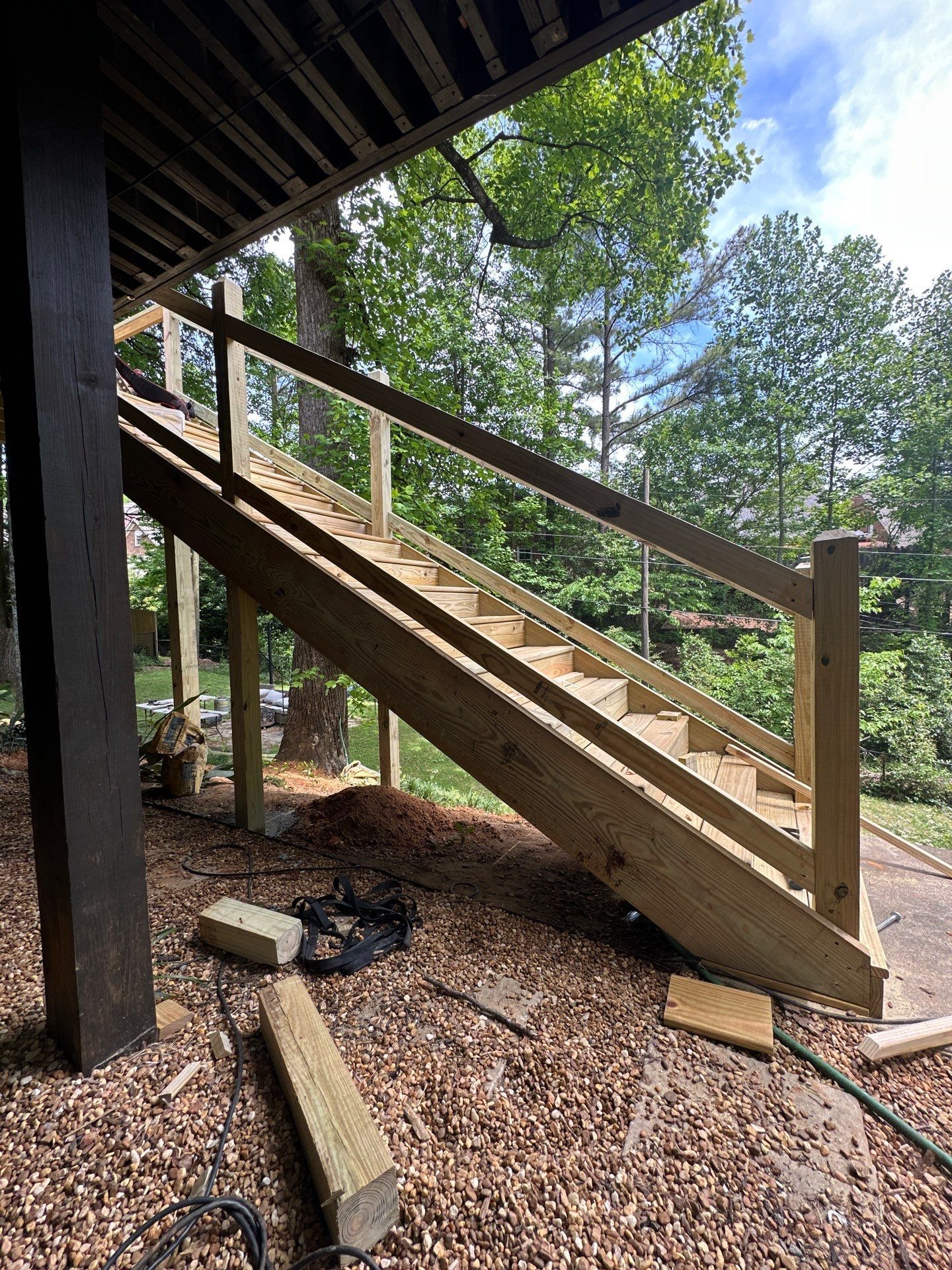 A custom wooden deck staircase under construction at a home on Woodmere Dr in Vestavia Hills.