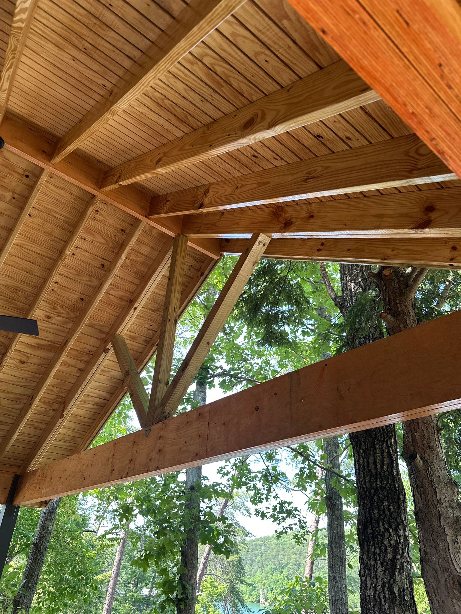 Exposed wood rafters and tongue-and-groove ceiling on a custom deck frame overlooking Smith Lake in Jasper.