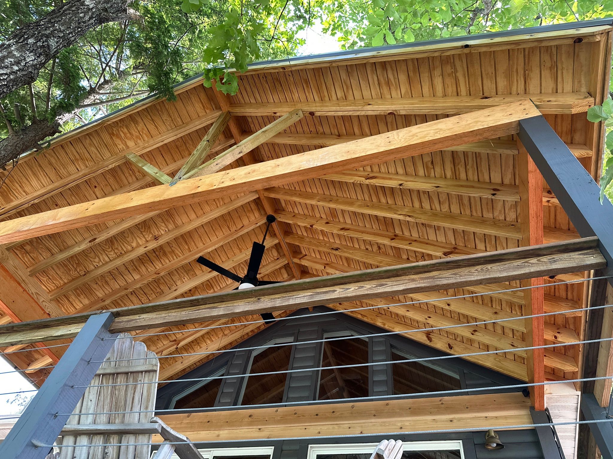 Exposed wood timber framing and tongue-and-groove ceiling on a custom deck at Smith Lake in Jasper.
