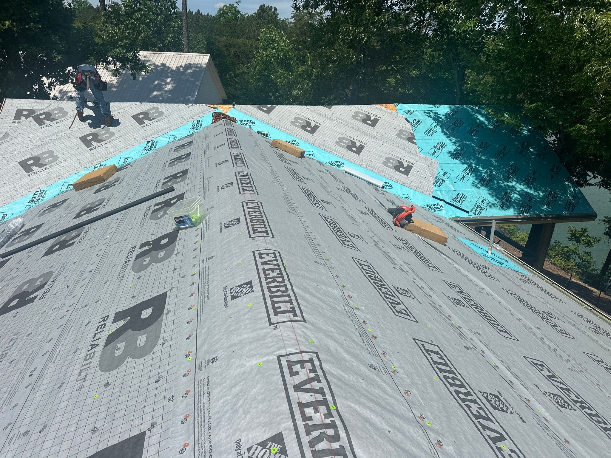 Roof replacement in progress featuring underlayment installation on a residential home at Smith Lake in Jasper.