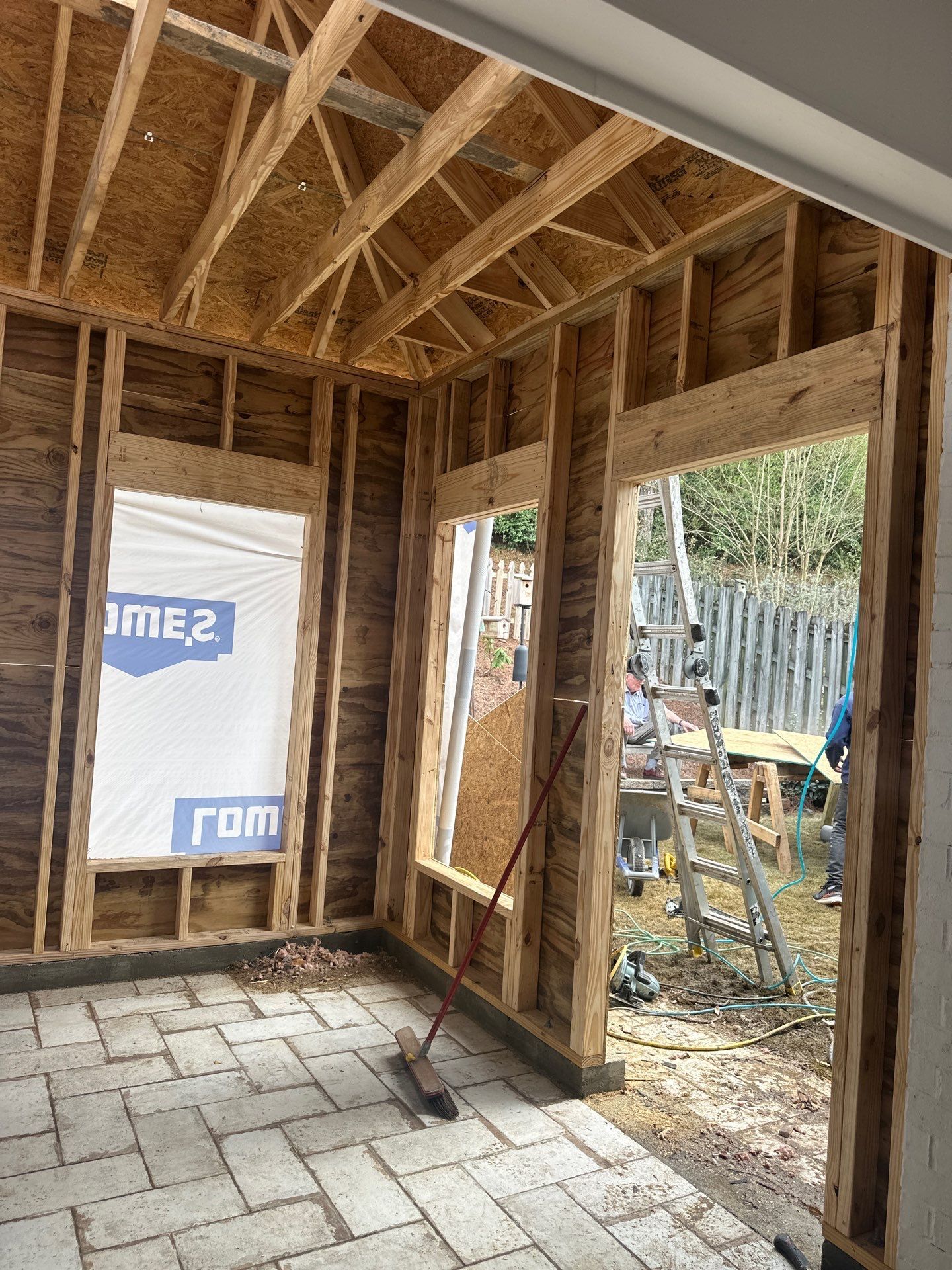 Interior view of new roof framing and wall construction for a home addition project in Hoover, Greystone.
