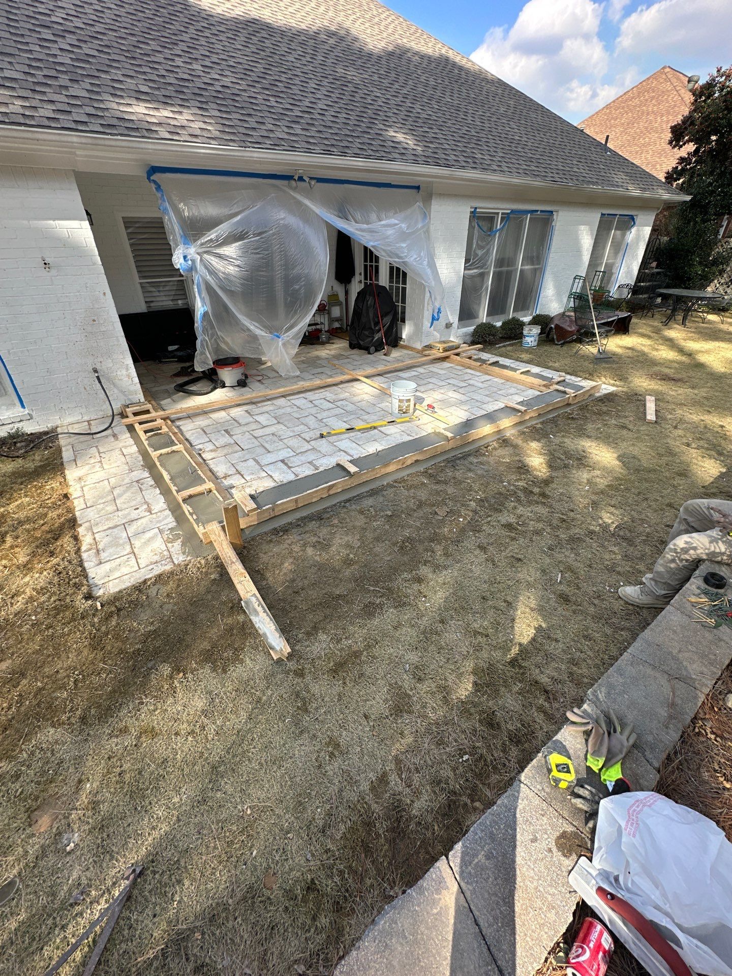 Completed roof replacement and white gutter installation on a white brick house in Greystone, Hoover.