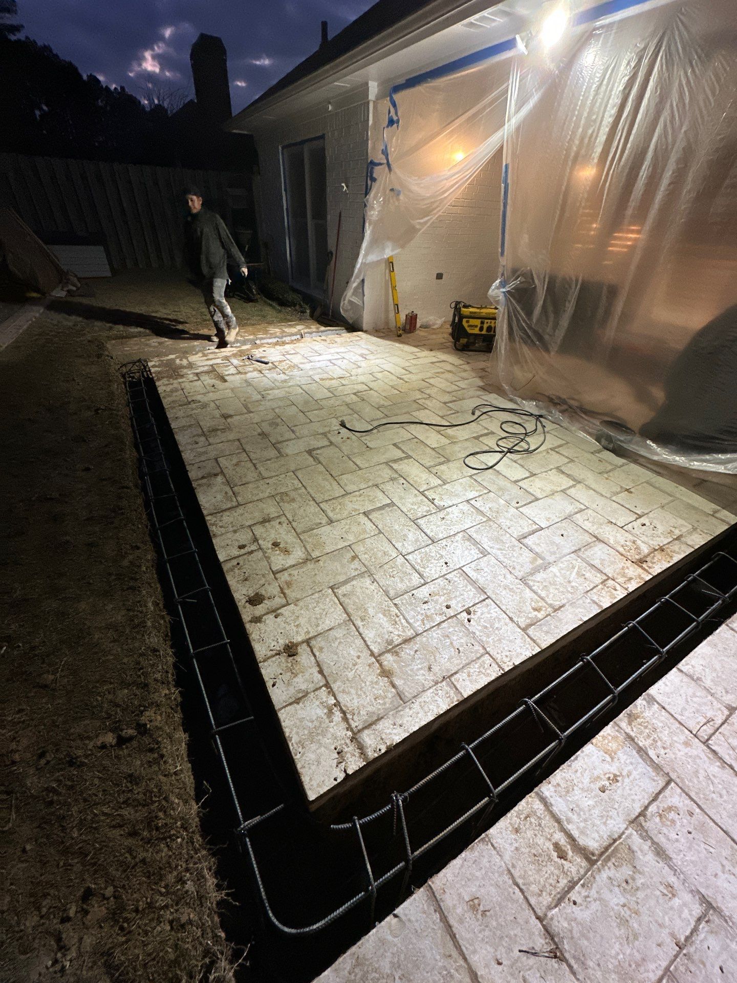 Residential stone patio installation with rebar reinforcement in Hoover, Greystone.