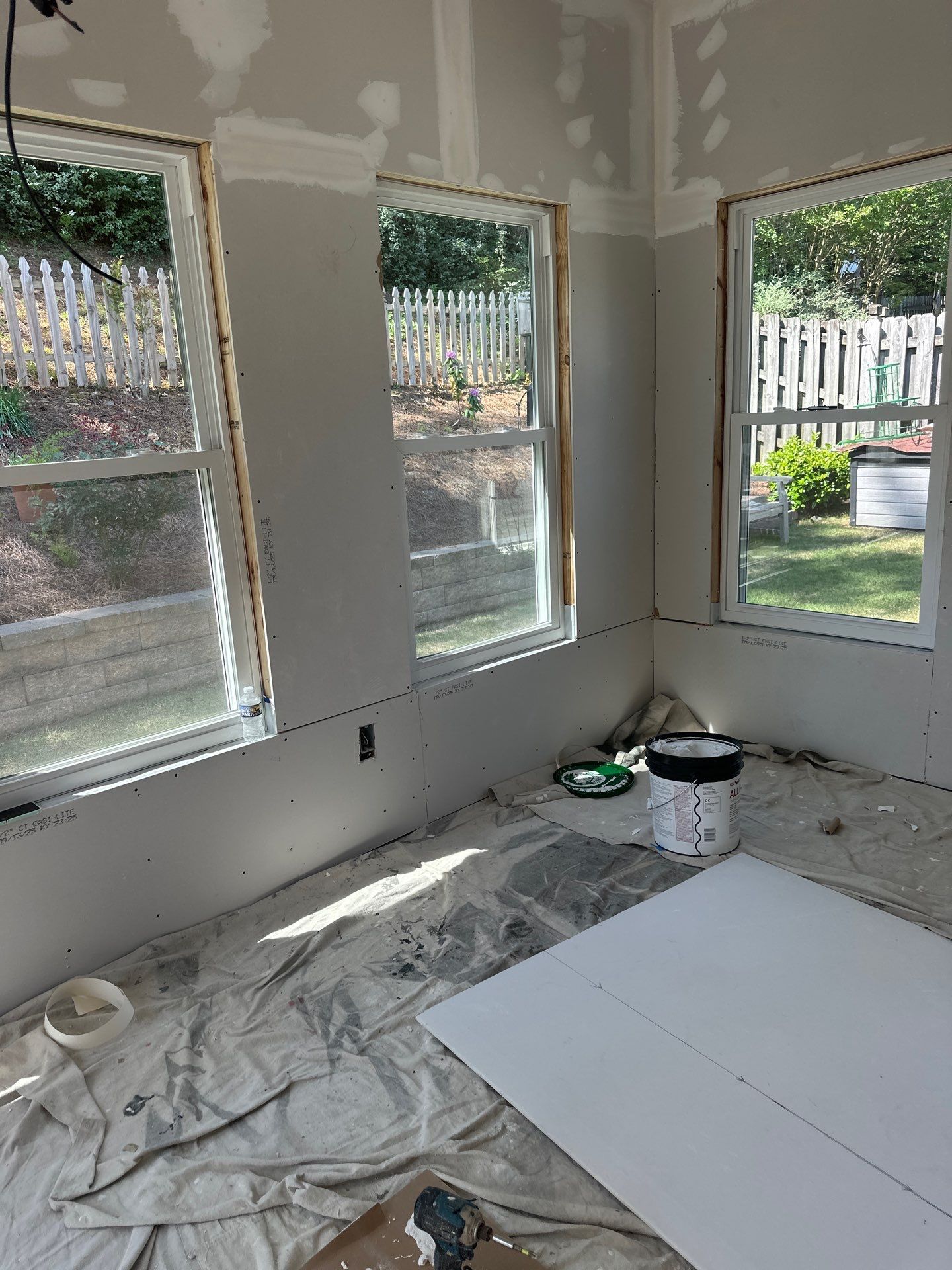 New drywall installed around windows during a home renovation project in Greystone, Hoover.