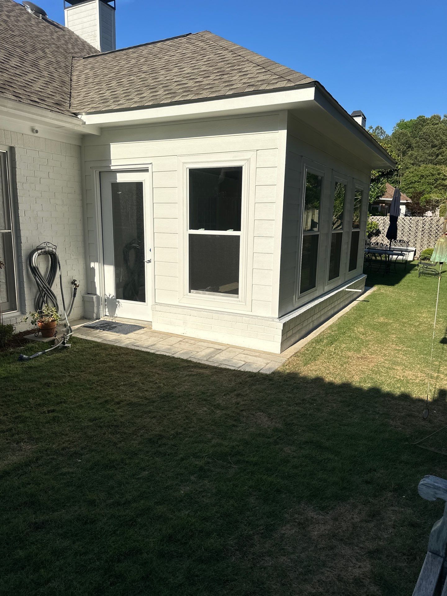 A new white siding installation on a home addition in the Greystone neighborhood of Hoover.