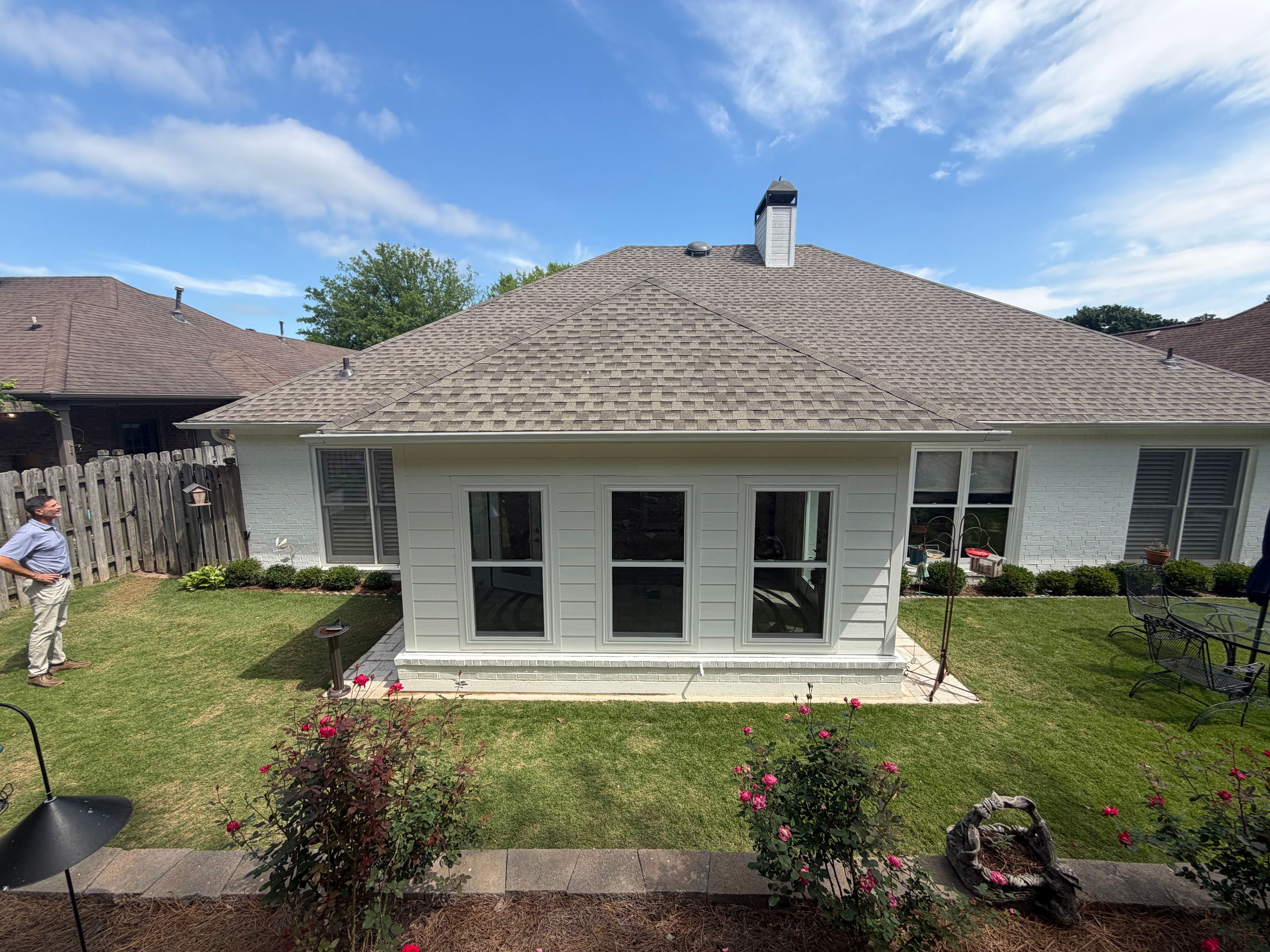 Enclosed porch addition on a home in Greystone, Hoover featuring a newly installed roof and white horizontal siding on a rear addition.