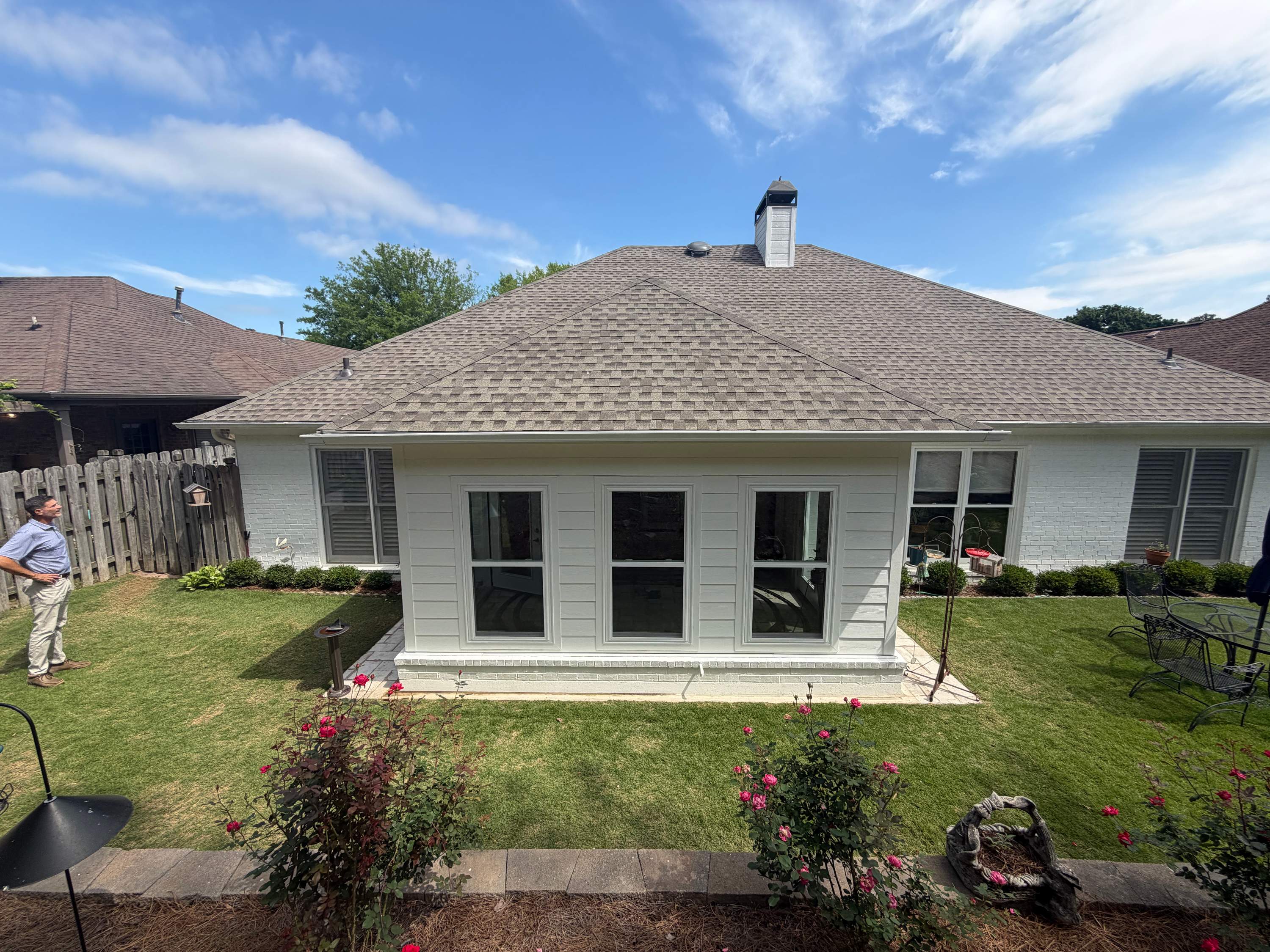 Enclosed porch addition on a home in Greystone, Hoover featuring a newly installed roof and white horizontal siding on a rear addition.