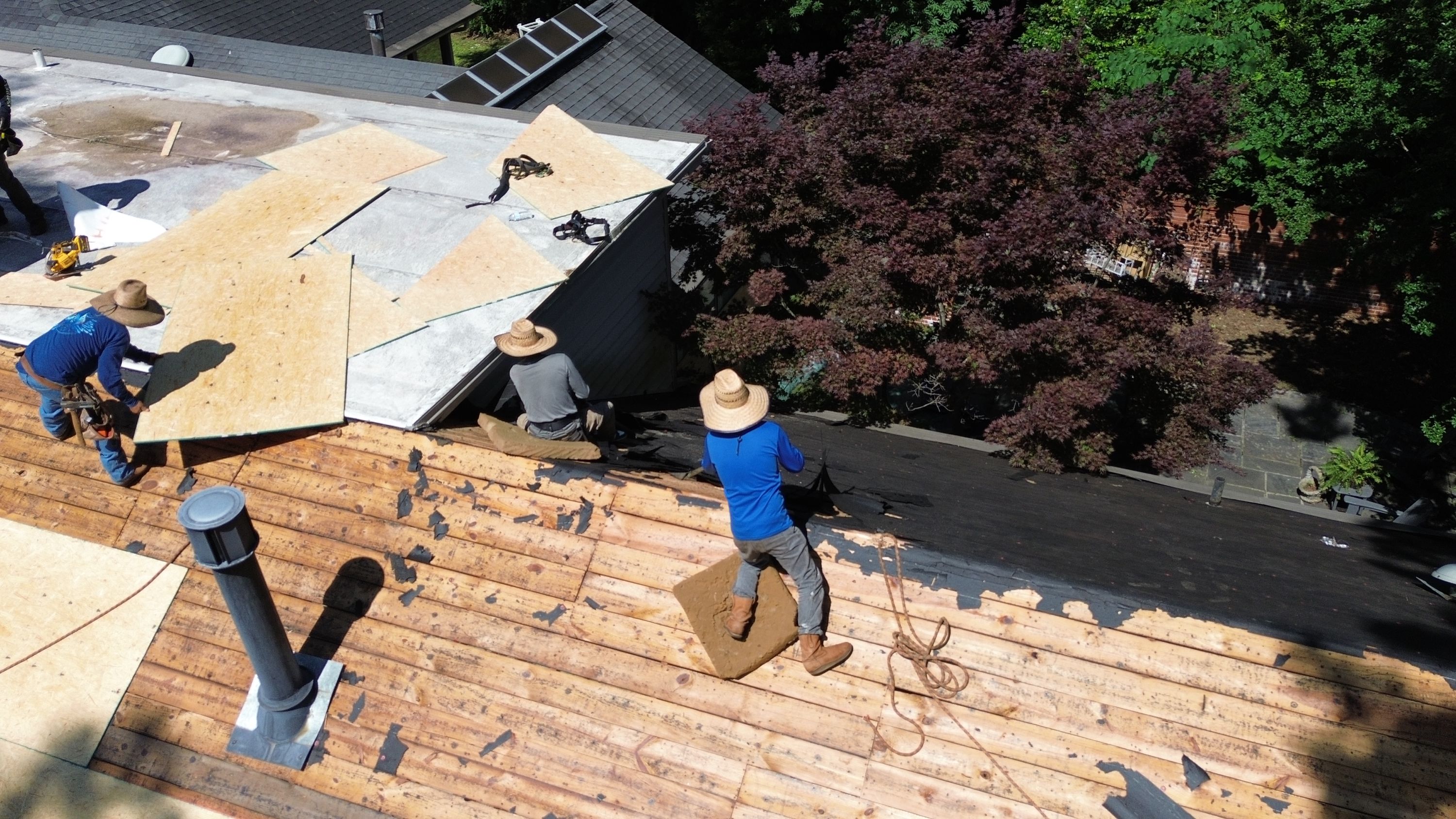 Preparing wood decking and plywood sheathing during a roof replacement in Mountain Brook.
