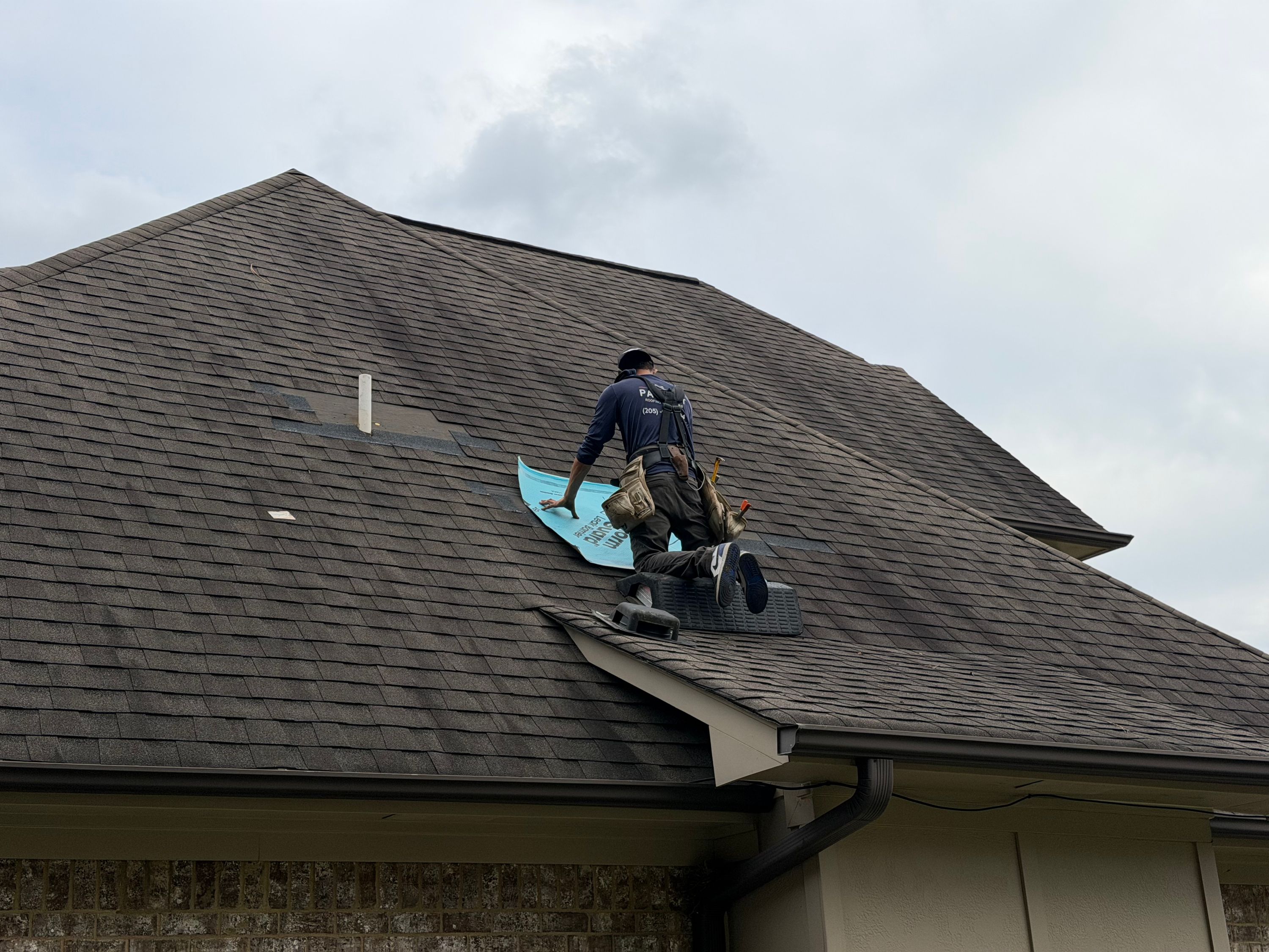 Blue leak barrier underlayment protects the shingles during a Willow Branch roof repair.