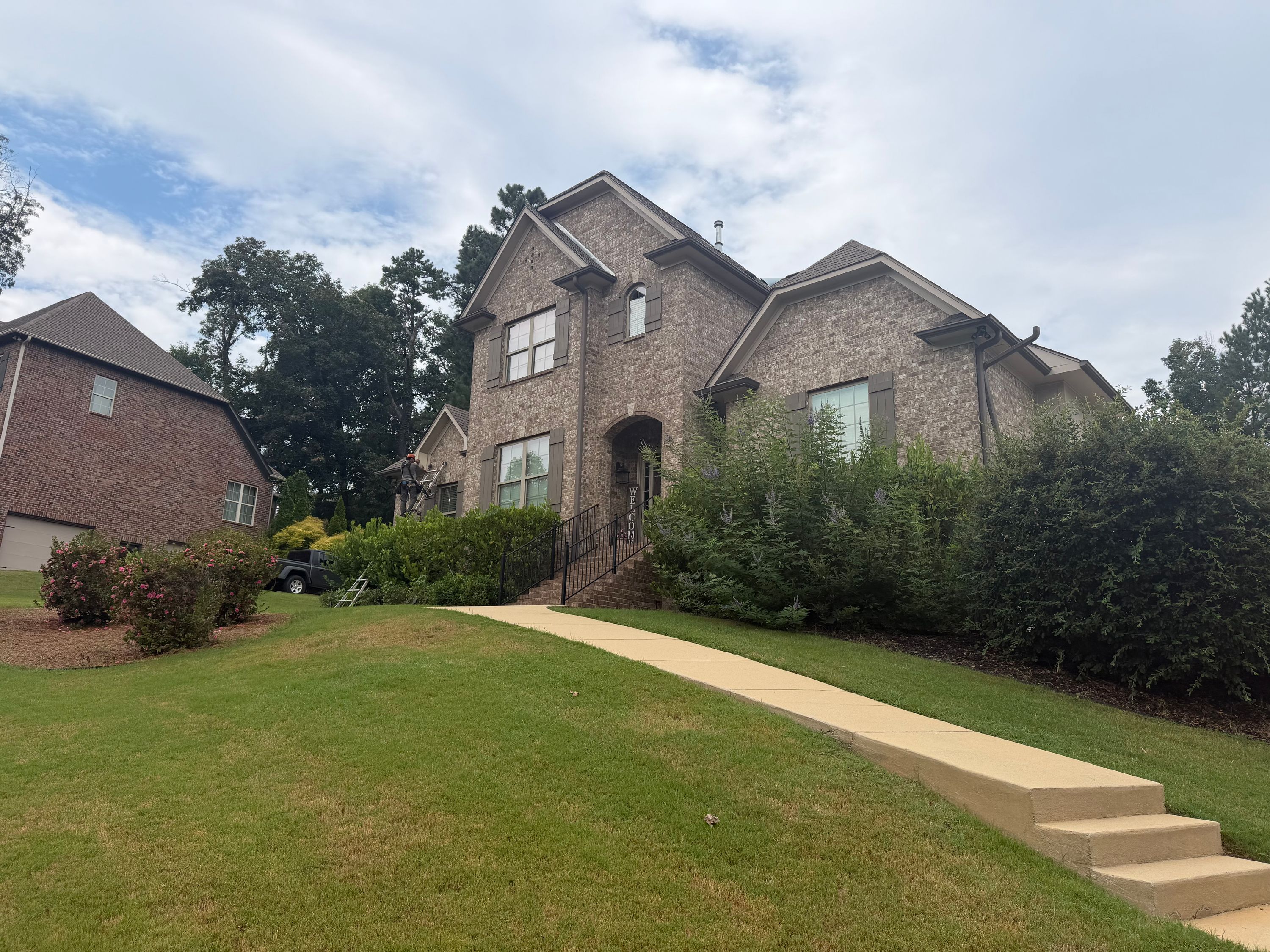 This completed Chelsea roof repair project highlights the sturdy shingles on a two-story brick home.