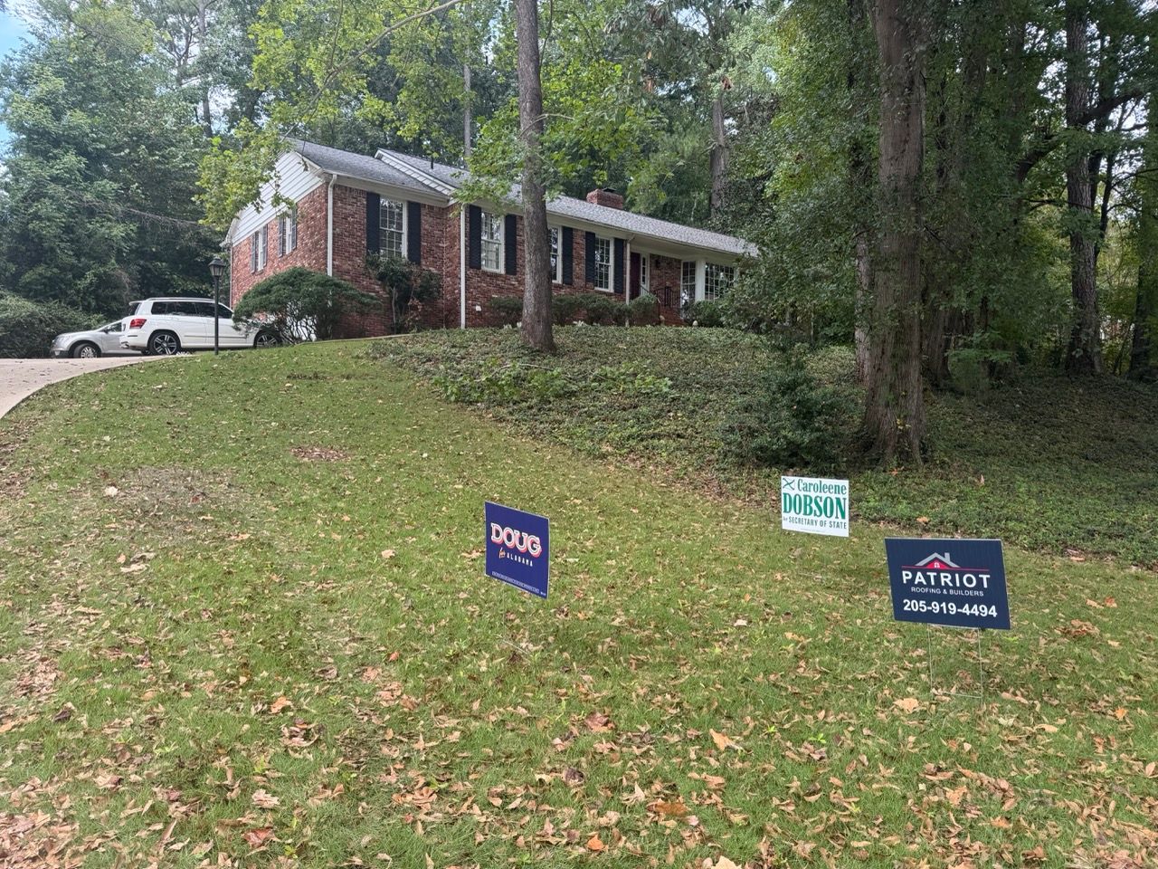 New grey shingles and white gutters installed on a brick ranch-style home in Cherokee Bend.