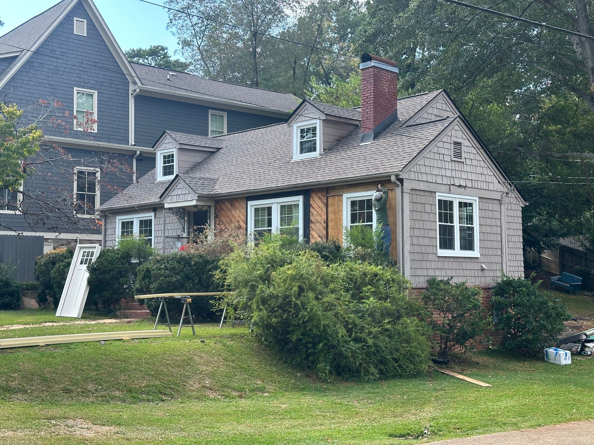 Professional window replacement and siding installation in progress on a residential home in Homewood, AL.