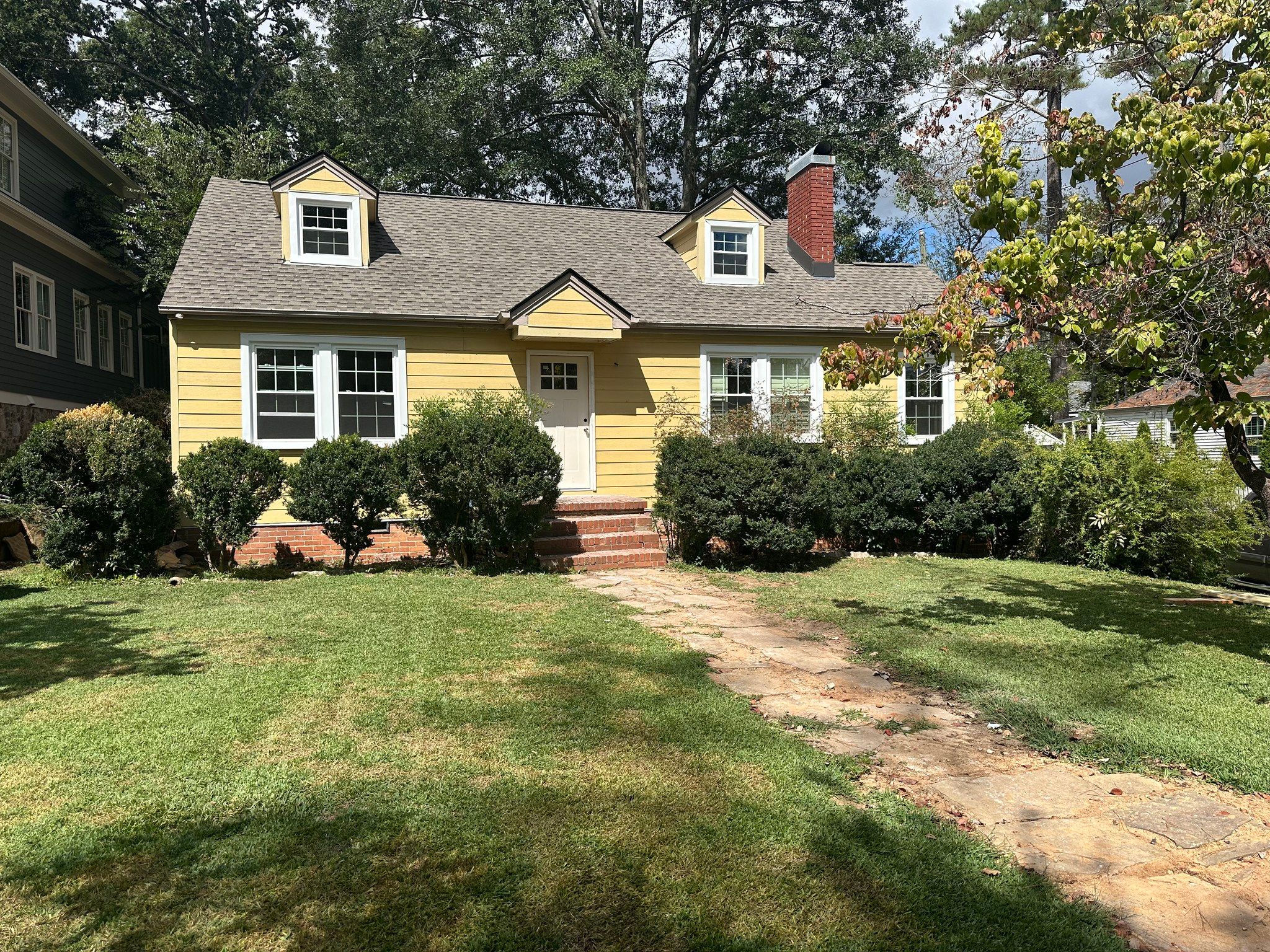 Front exterior of a Homewood house during the process of window and siding replacement.