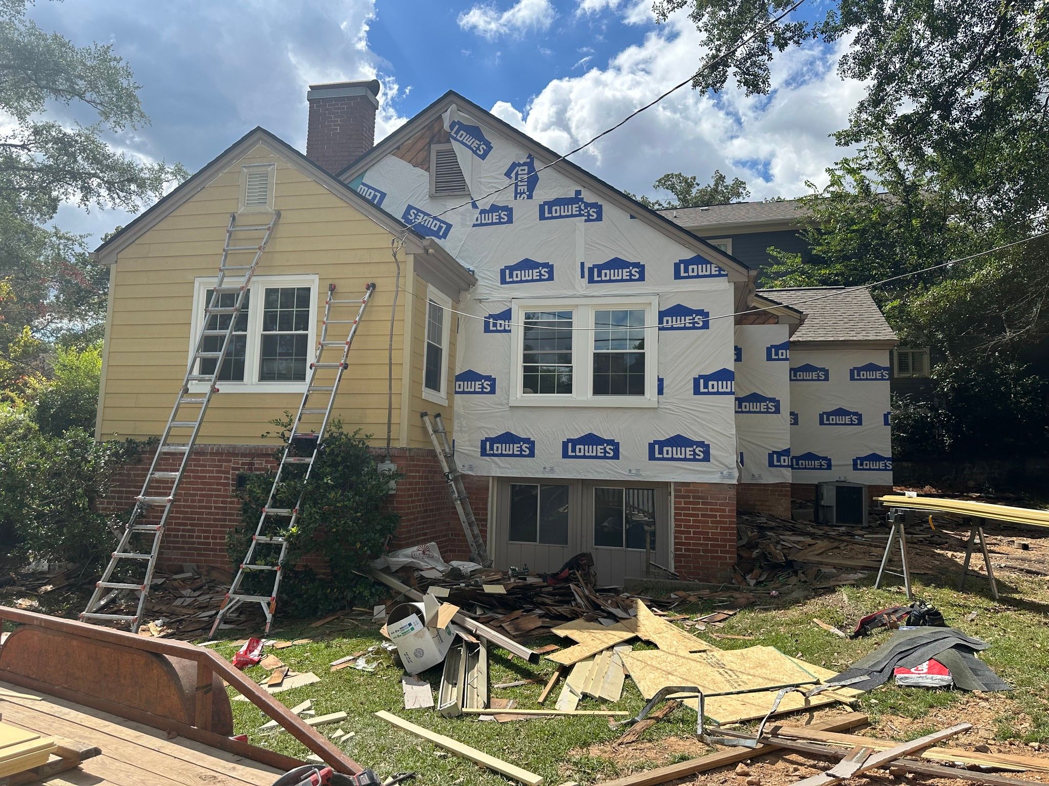 Rear of the house showing protective house wrap and newly installed windows in Edgewood, Homewood.