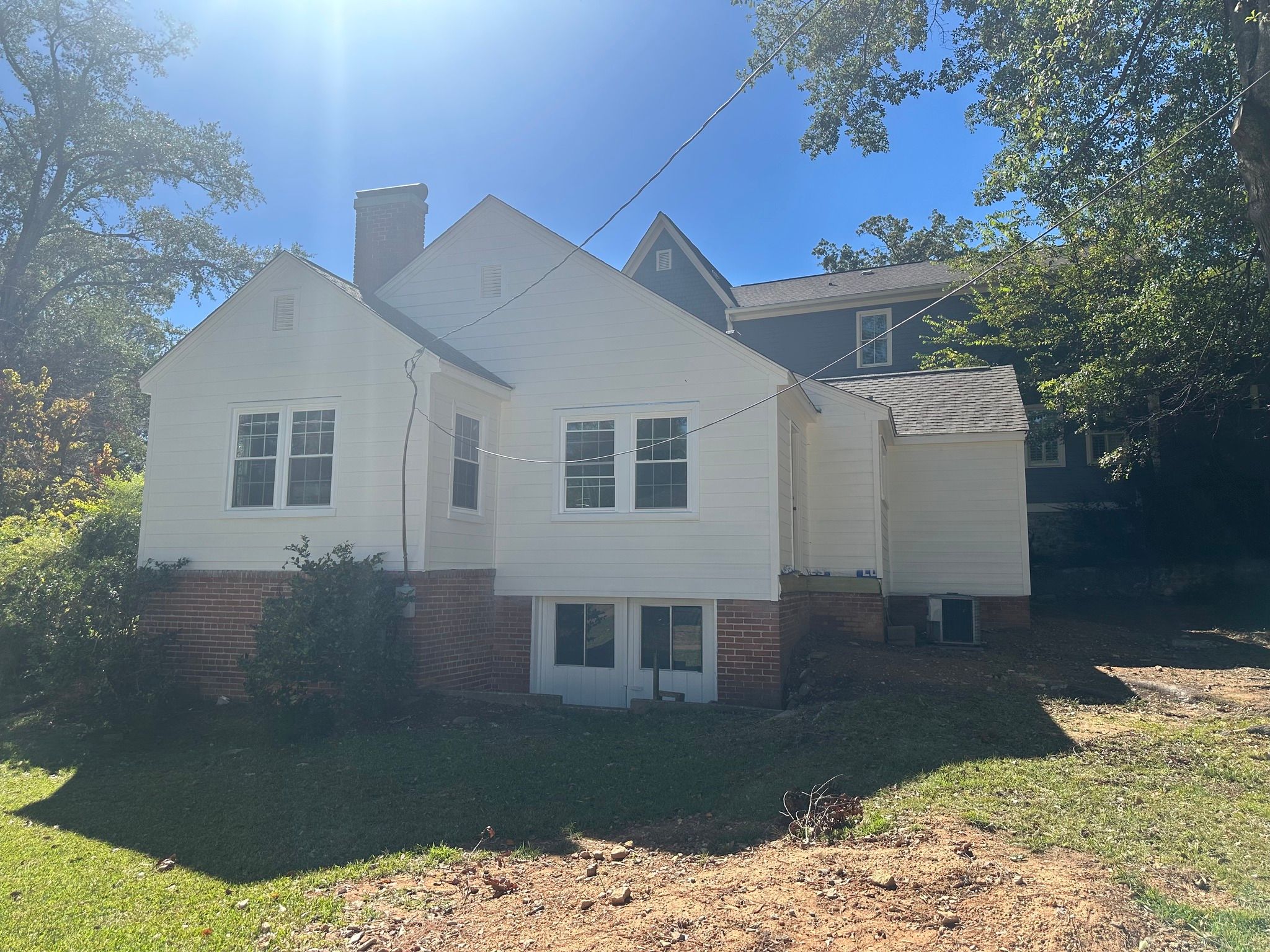 Completed exterior renovation with white siding and new double-hung windows in Homewood, AL.