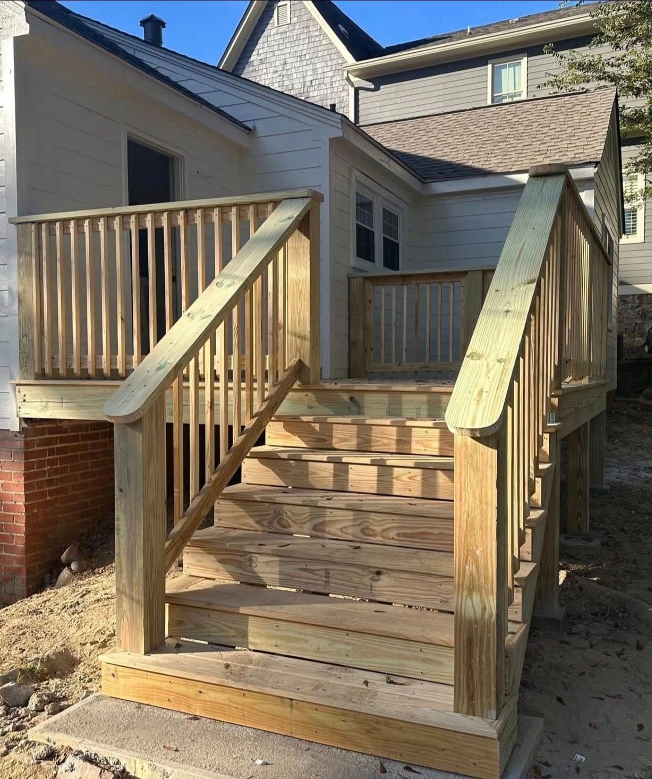 Custom wooden deck and stairs built during an exterior home remodeling project in Homewood, AL.