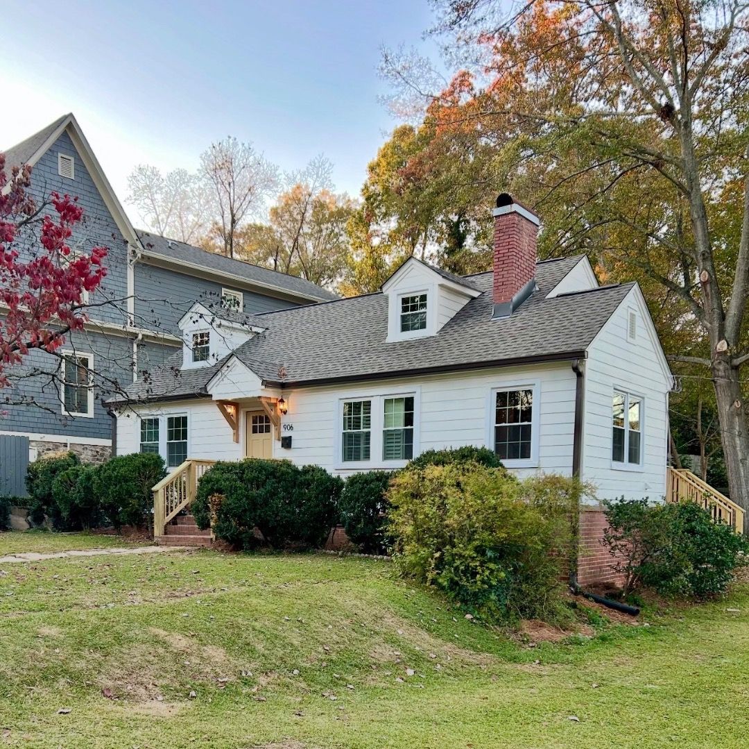 Finished home renovation in Homewood featuring clean white siding and high-quality window replacements.