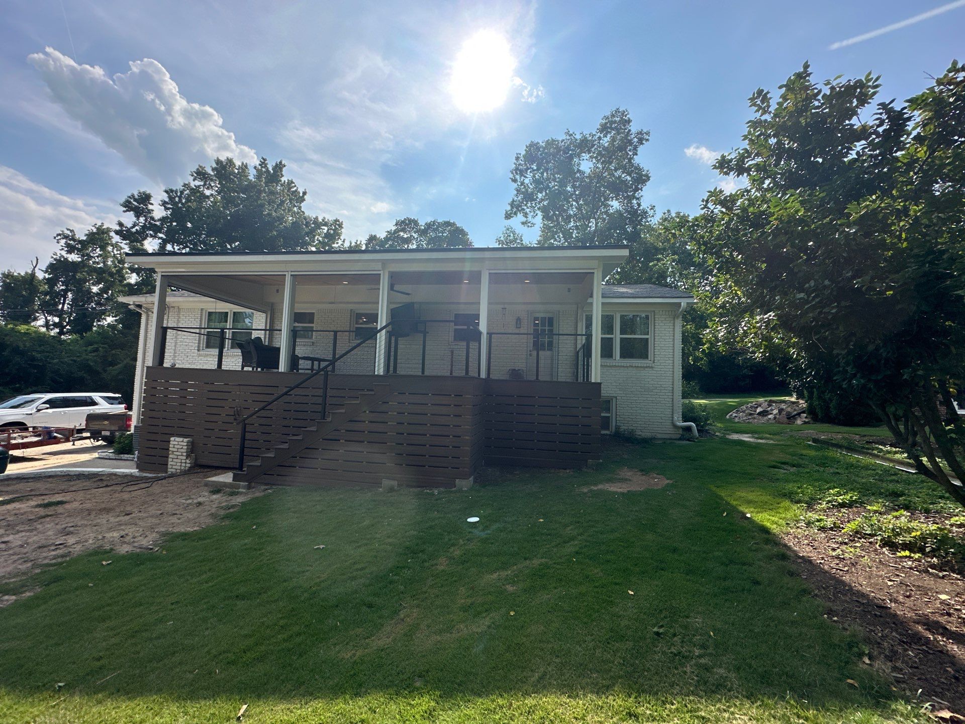 Wide shot of a finished outdoor living room and custom elevated deck at a residence in Vestavia North, Alabama.