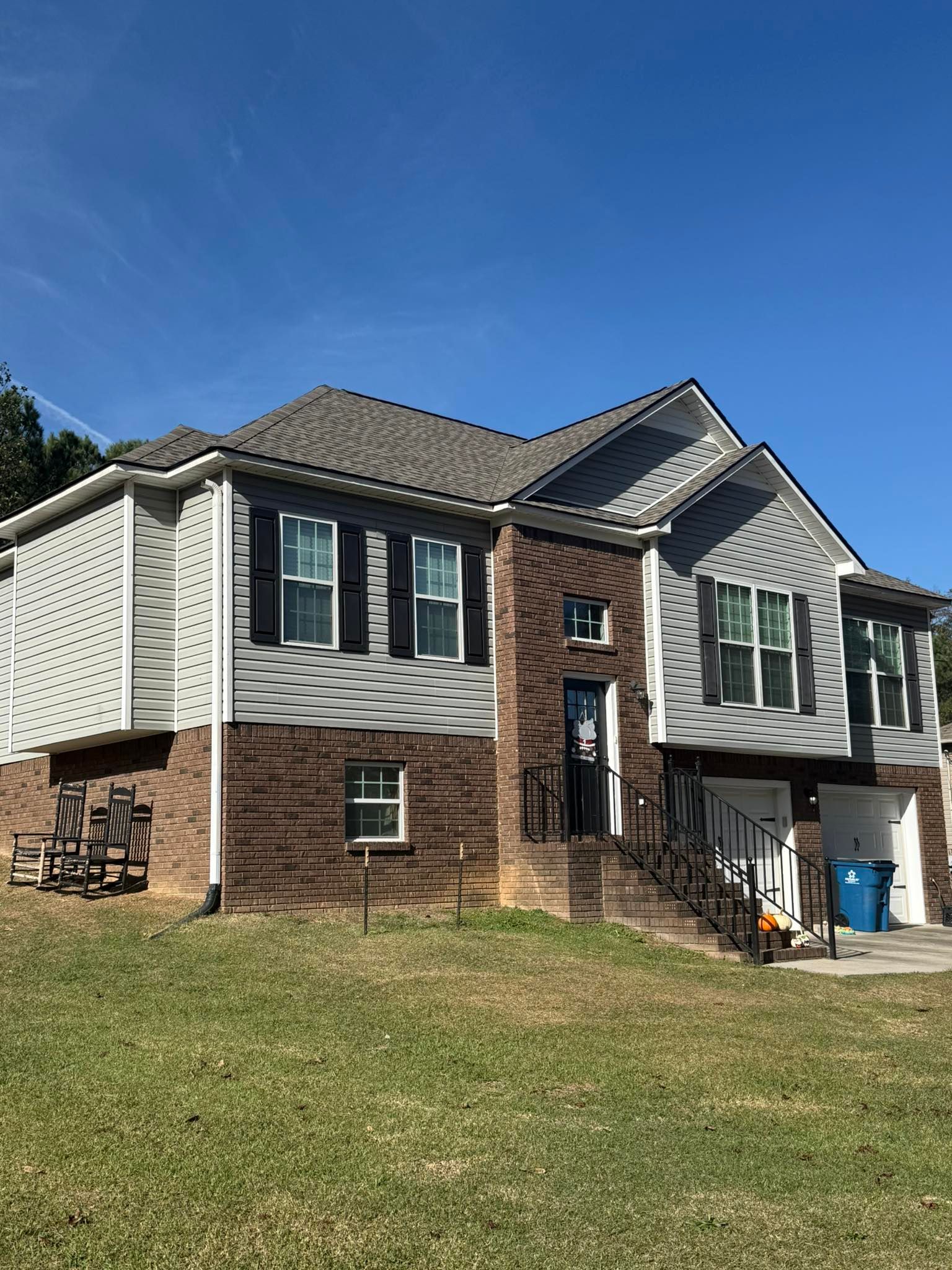 Front view of a newly installed asphalt shingle roof on a multi-level home in Trussville, AL.