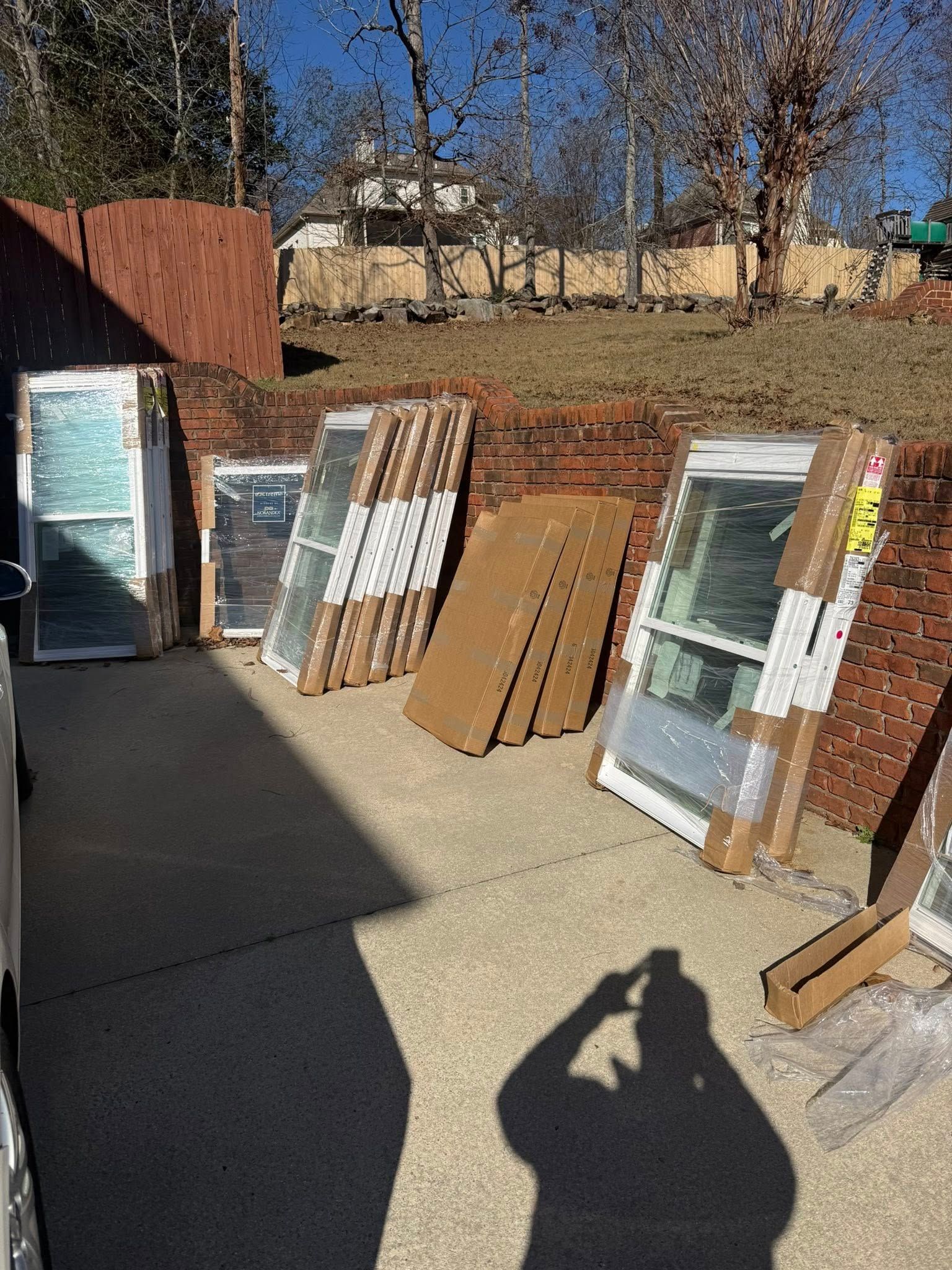 New replacement window units staged and ready for installation at a Hoover job site.
